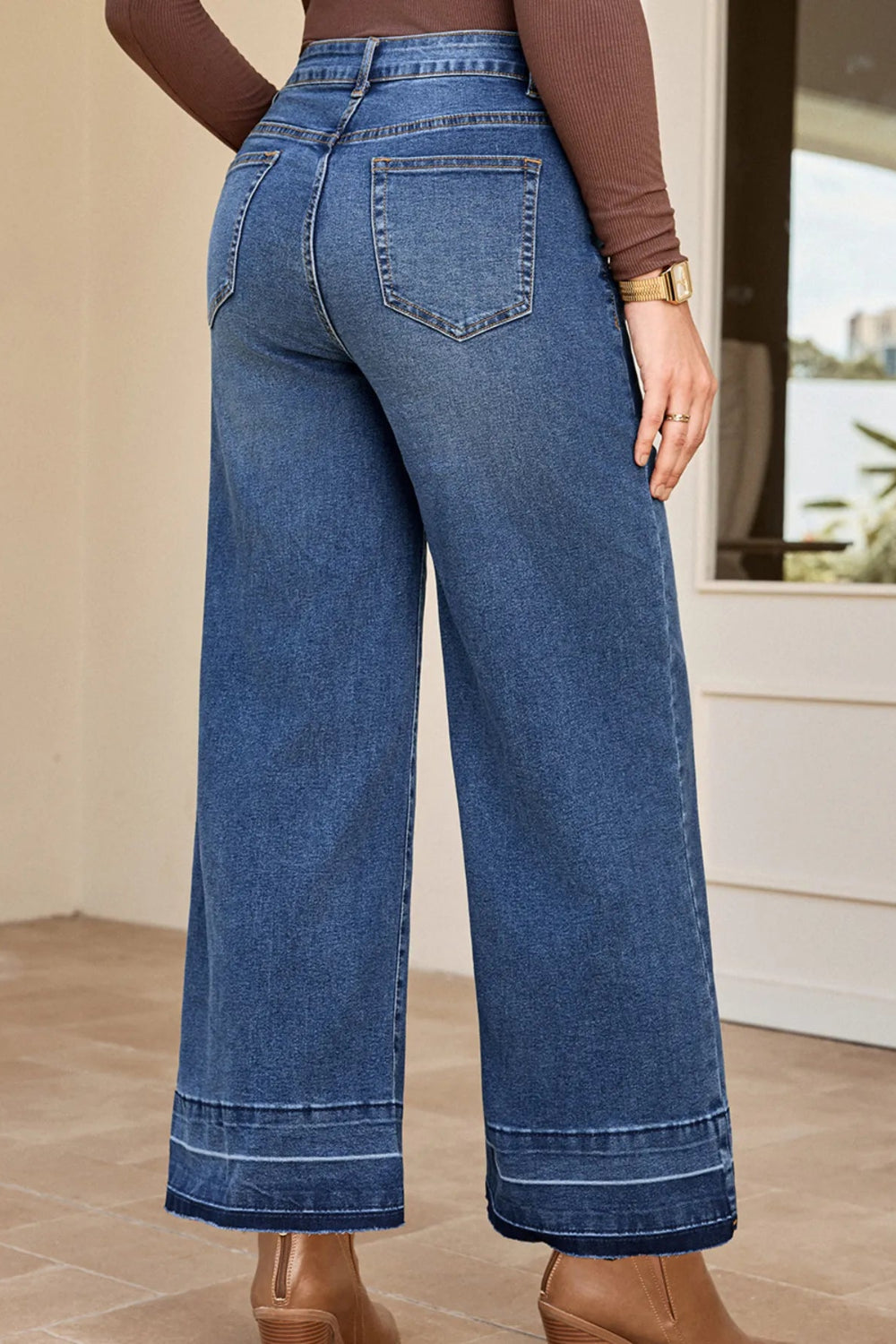 Jeans, high-rise, drop hem, raw hem, wide leg, pocketed, belt loops, button/zipper closure, vintage wash, some stretch, back view