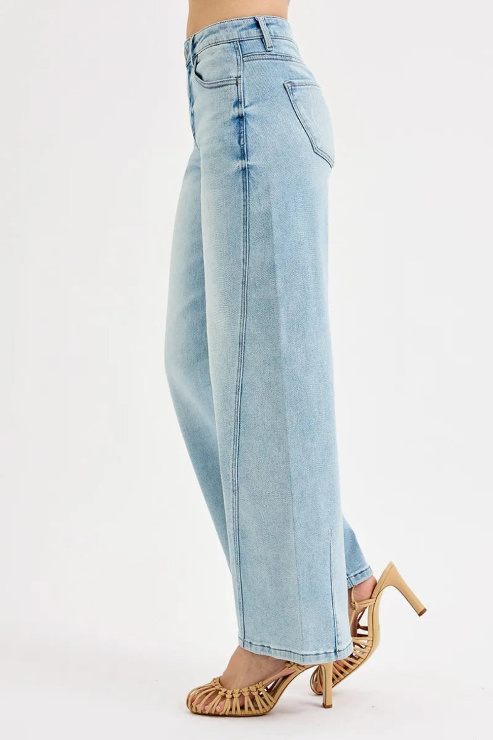 Risen blue jeans, full-size mid-rise, barrel fit, 5-pocket detail, button-zipper closure, belt looped, light wash, slightly stretchy, side view