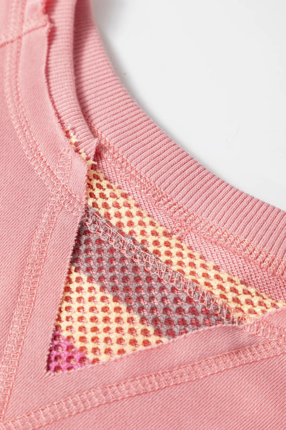 Top, mesh, patchwork, exposed seam, long sleeve, pullover, round neck, ribbed hem, slightly stretchy, close up view