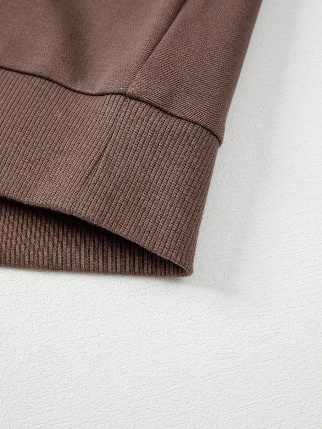 A Change Of Pace Sweatshirt in mocha brown with rust-orange and cream color-block sleeves, shown close up view.