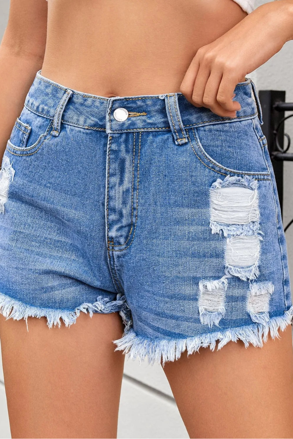 Distressed, Raw hem, High waist, Zipper and button closure, Functioning pockets,  No stretch, Denim shorts Front view