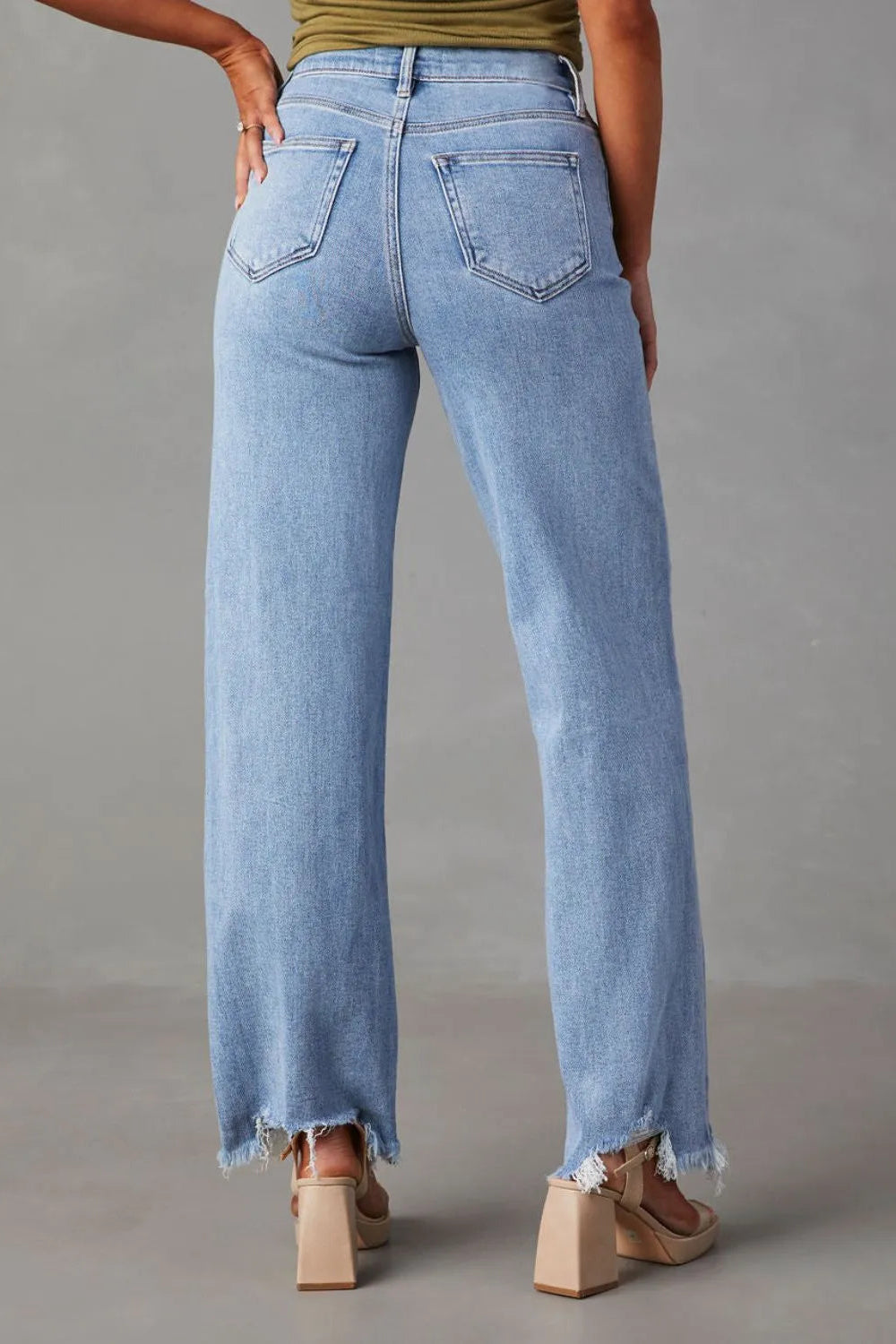 Jeans, high-waist, straight leg, 5 pocket design, light wash, raw hem, destroyed, button/zipper closure, belt loops, slightly stretchy, back view