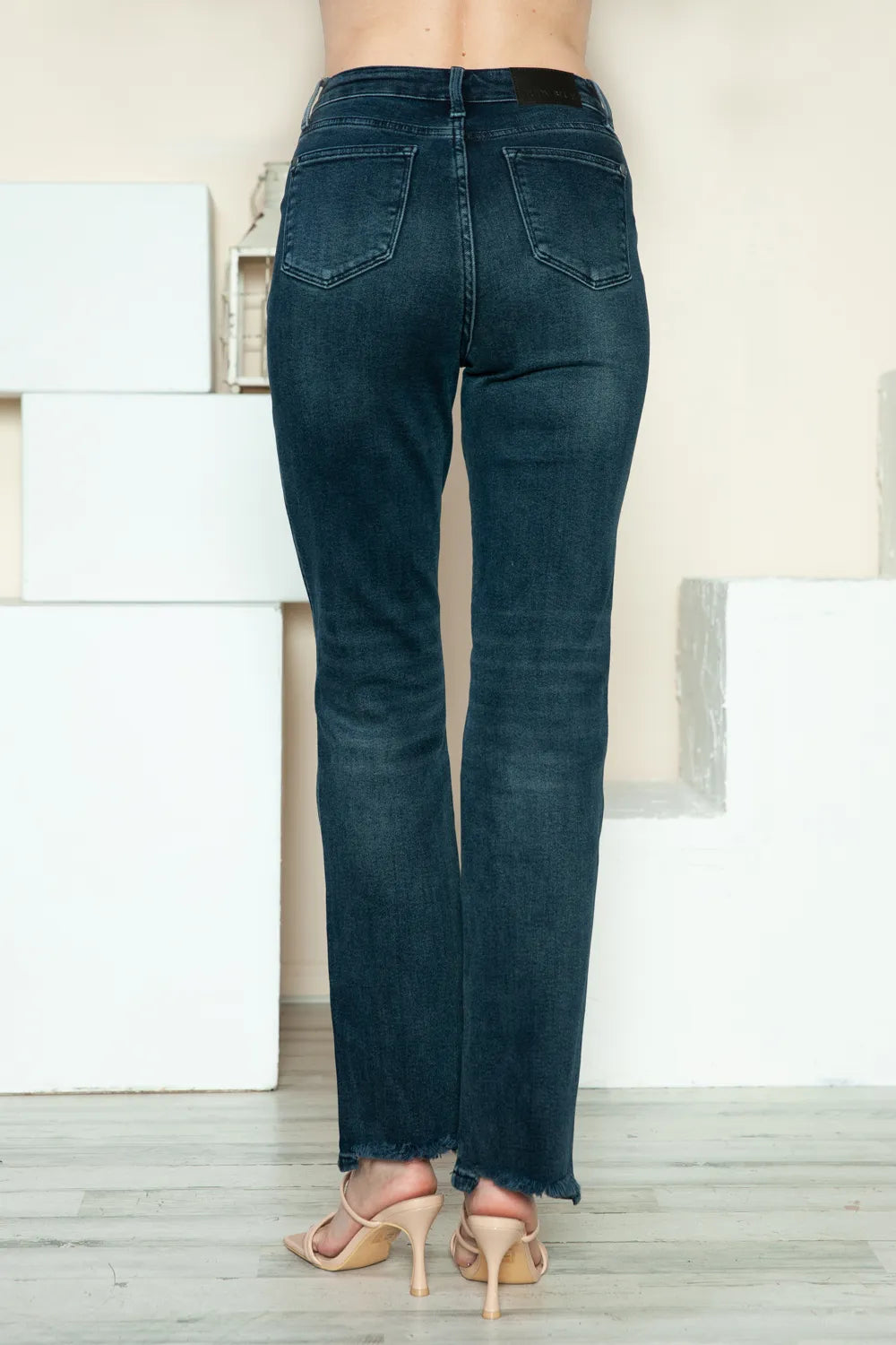 Judy Blue Button Fly Straight Leg Jeans feature a dark wash, raw hem, stretch fit, and classic pockets back view