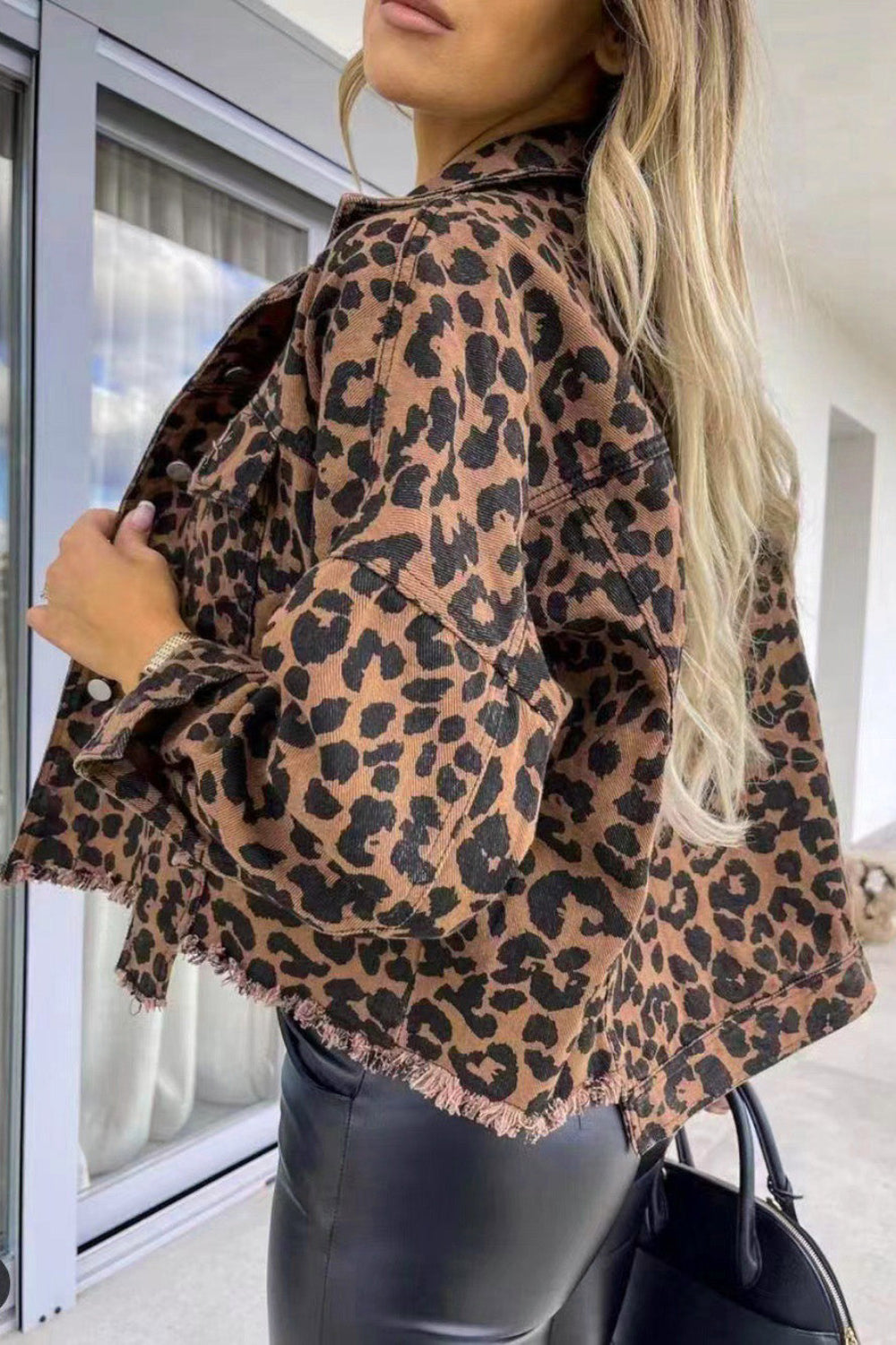 denim jacket, long sleeve, collared, drop shoulder, buttoned, pocketed, leopard print, distressed, no stretch, back view