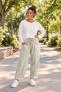 The Reece Pants in red and cream gingham with wide cuffed legs, a drawstring waist, front pockets, and vertical seams front view.