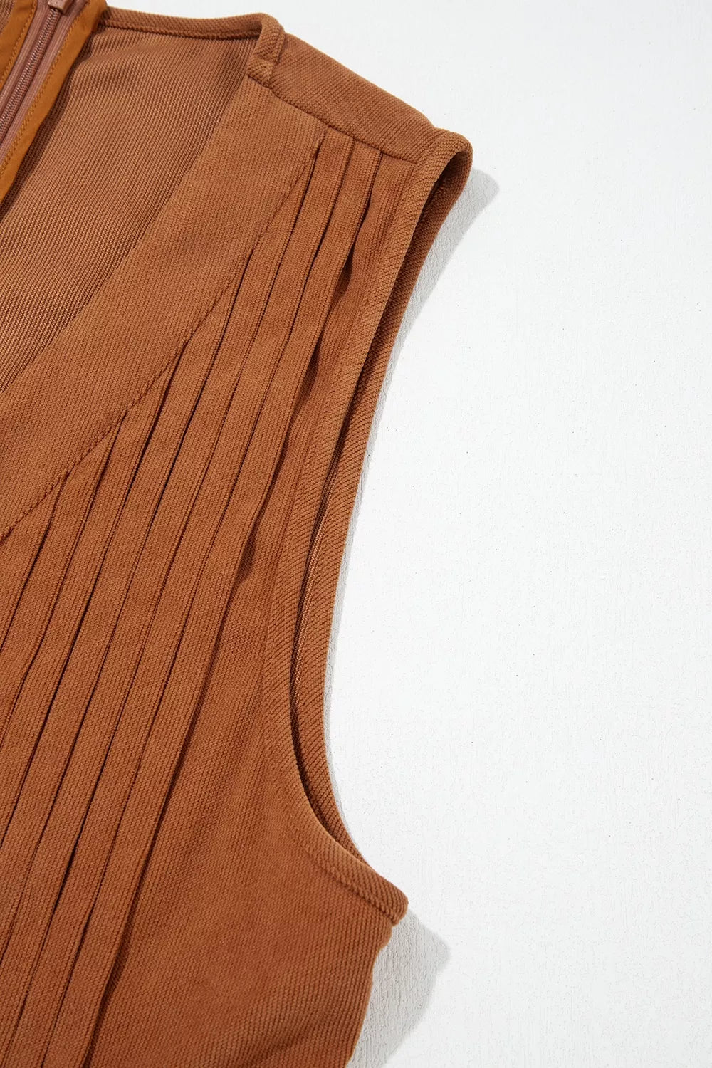 Front view of the As You Were Romper in rust brown corduroy with a tie V-neck, back zipper, pleated details, and side pockets.