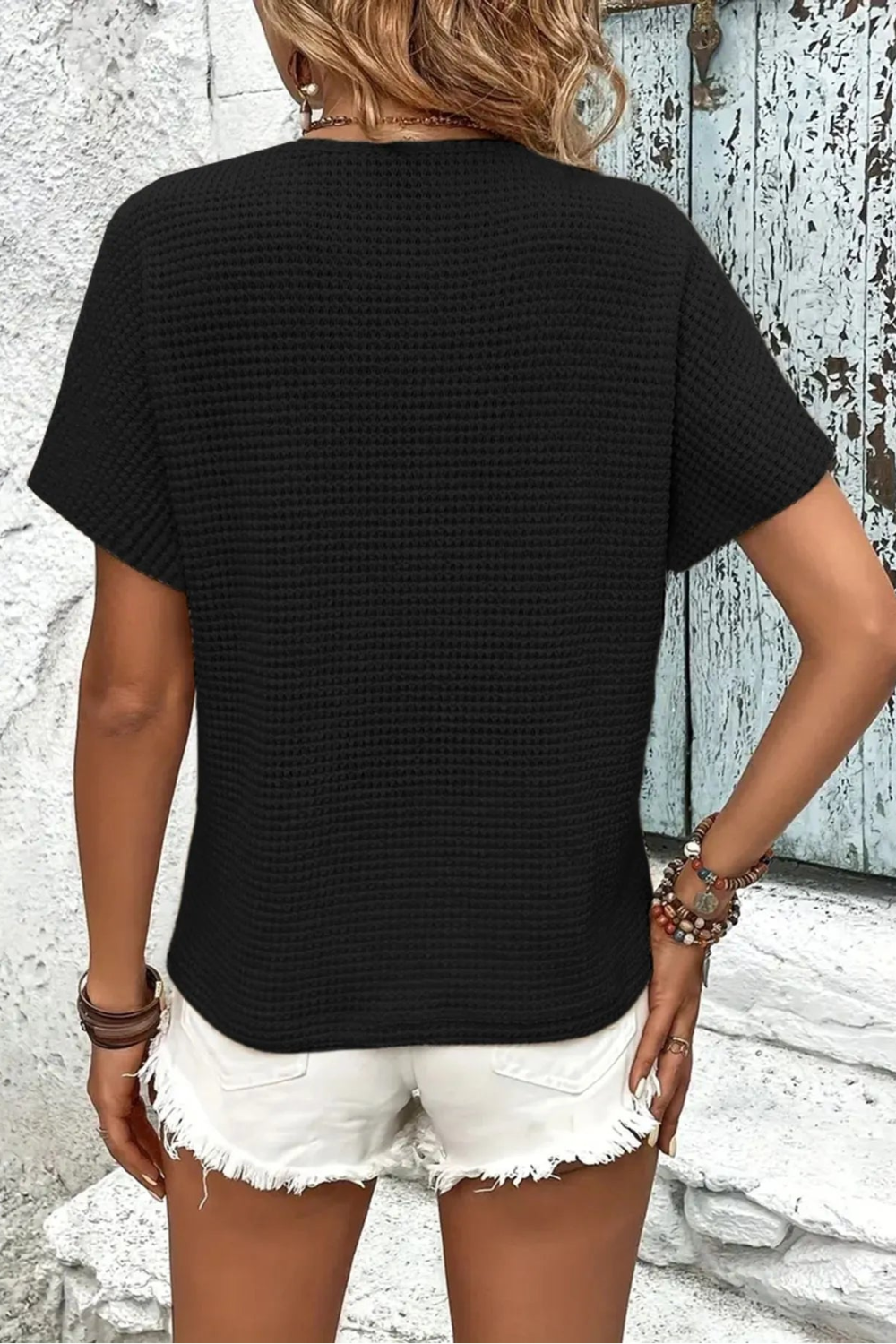 top, short sleeve, v-neck, buttoned, pullover, waffle knit, hangs at waist, slightly stretchy back view