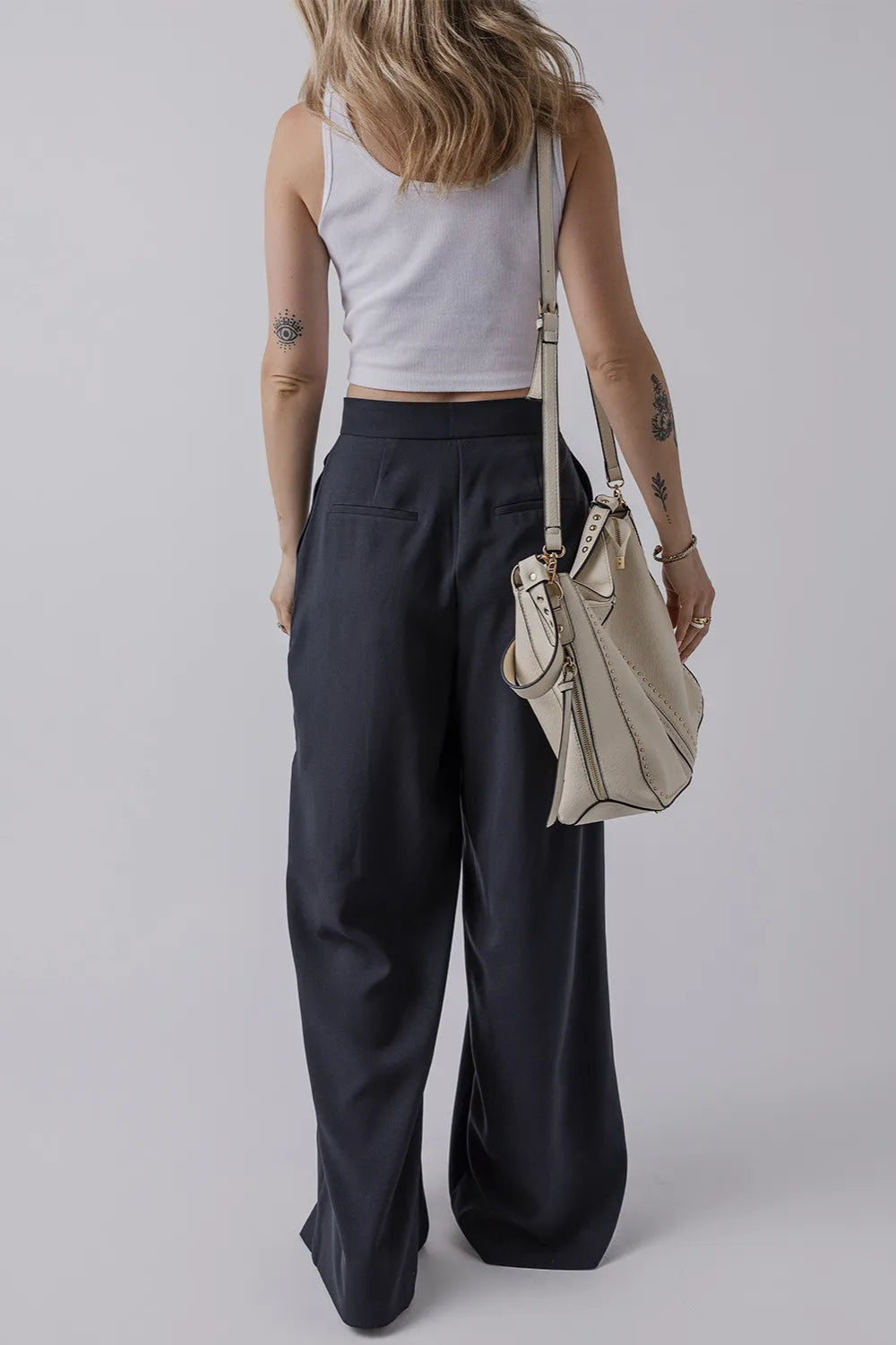 Pants, double button and zipper closure, large pleats, pocketed, wide leg, long, opaque, no stretch, double back pockets, back view
