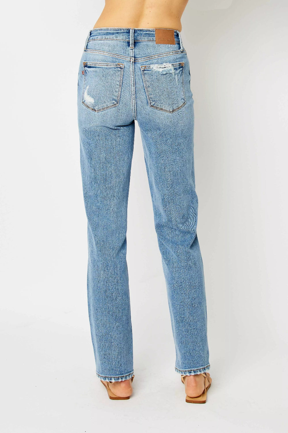 Judy Blue Jeans, full-size, high-rise, pocketed, belt loops, button/zipper closure, medium wash, straight leg, destroyed, raw hem, slightly stretchy, back view
