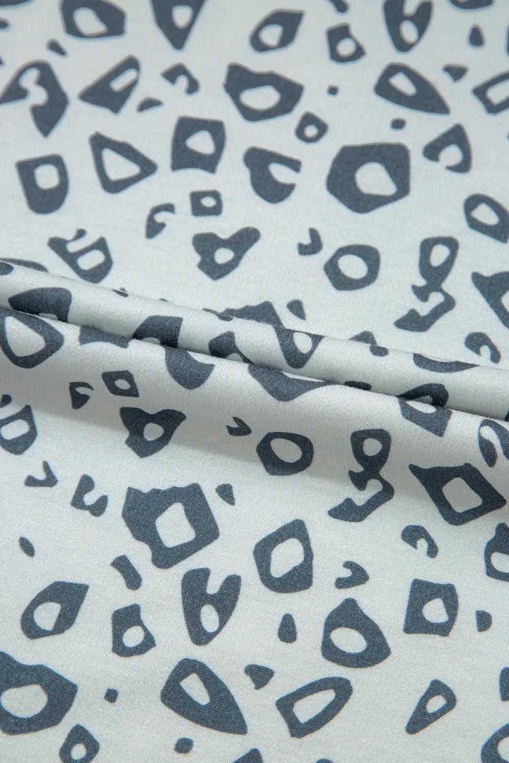 Pants, leopard print, high waist, elastic waistband, no drawstring, piping, side ties, pocketed, gray in color, some stretch close up view