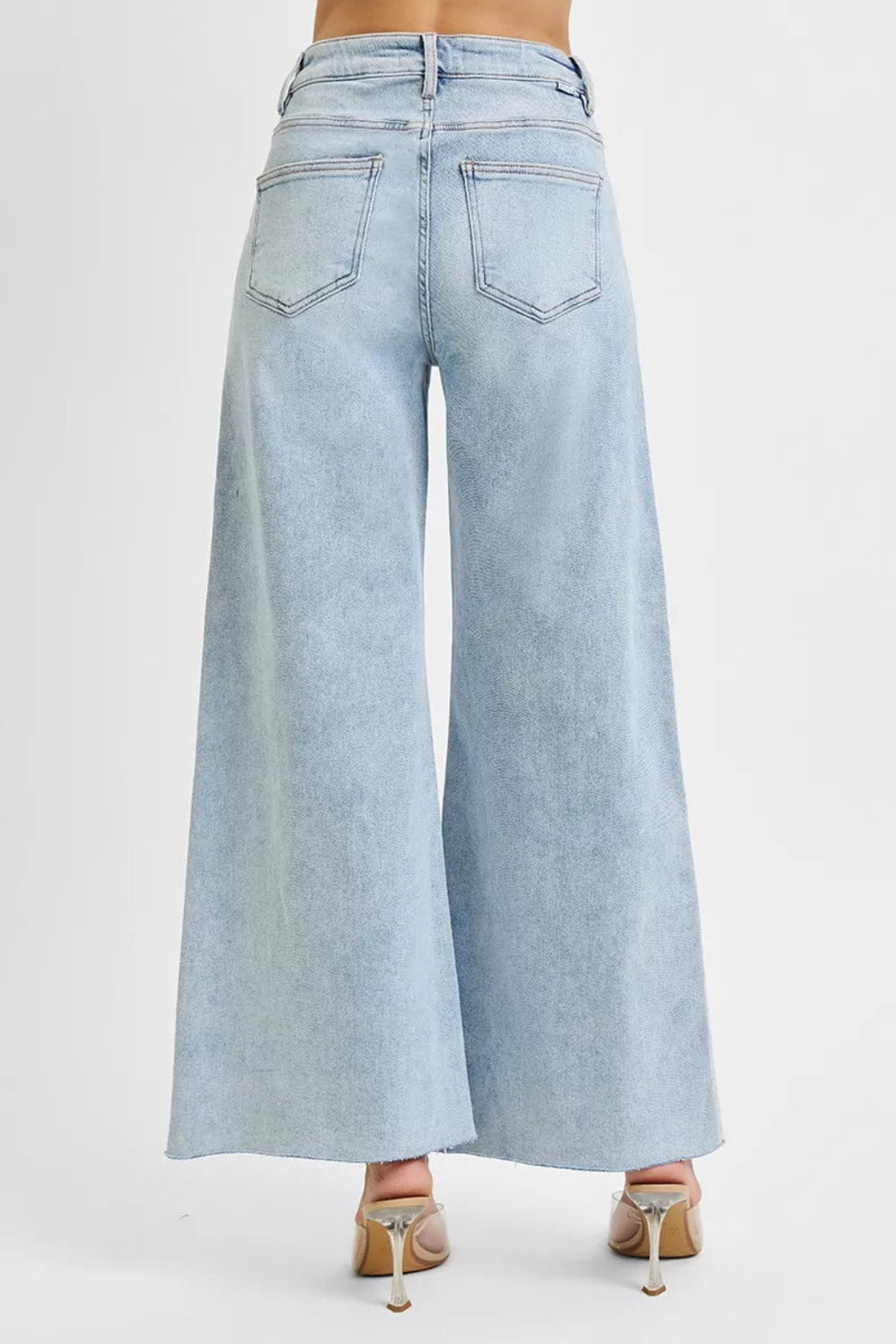 Risen Jeans, full-size, high-rise, wide leg, palazzo style, light wash, raw hem, button/zipper closure, belt loops, pocketed, slightly stretchy, back view
