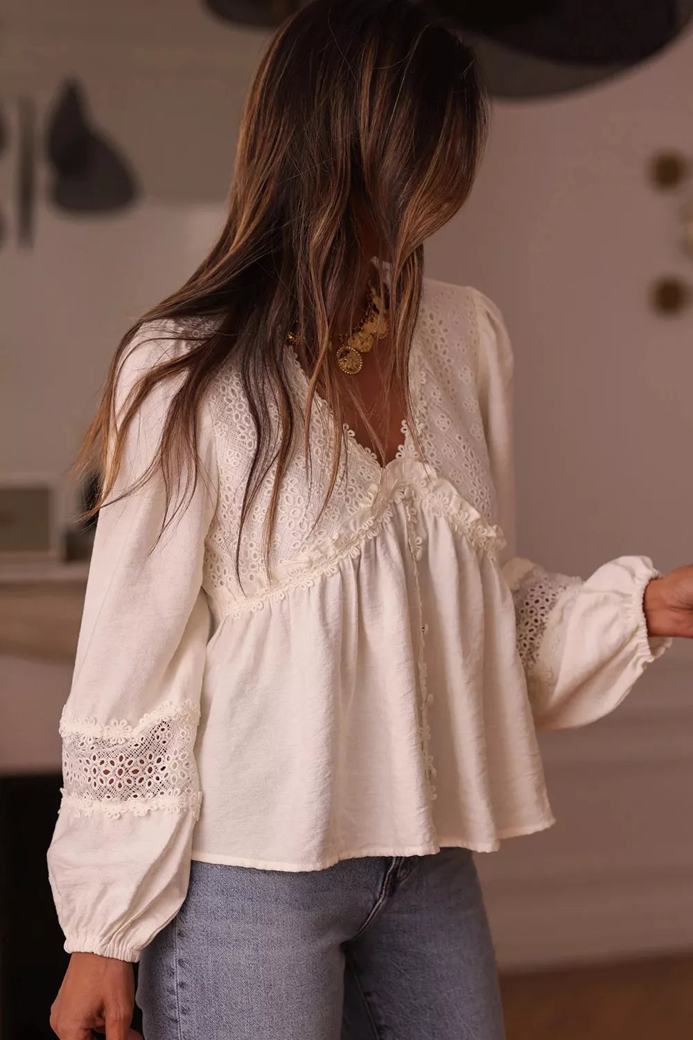 blouse, pullover, v-neck, long sleeve, buttoned, puff sleeve with elastic wrist, lace cutouts, ruffles, intricate detailing on sleeve and neckline, medium length, no stretch, front view