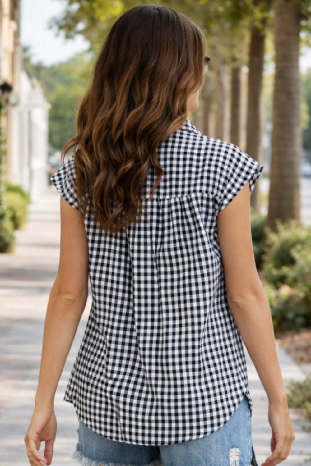 * Shirt
* Gingham print
* Sleeveless
* Collared
* Buttoned
* Pleated
* Curved hem
* No stretch