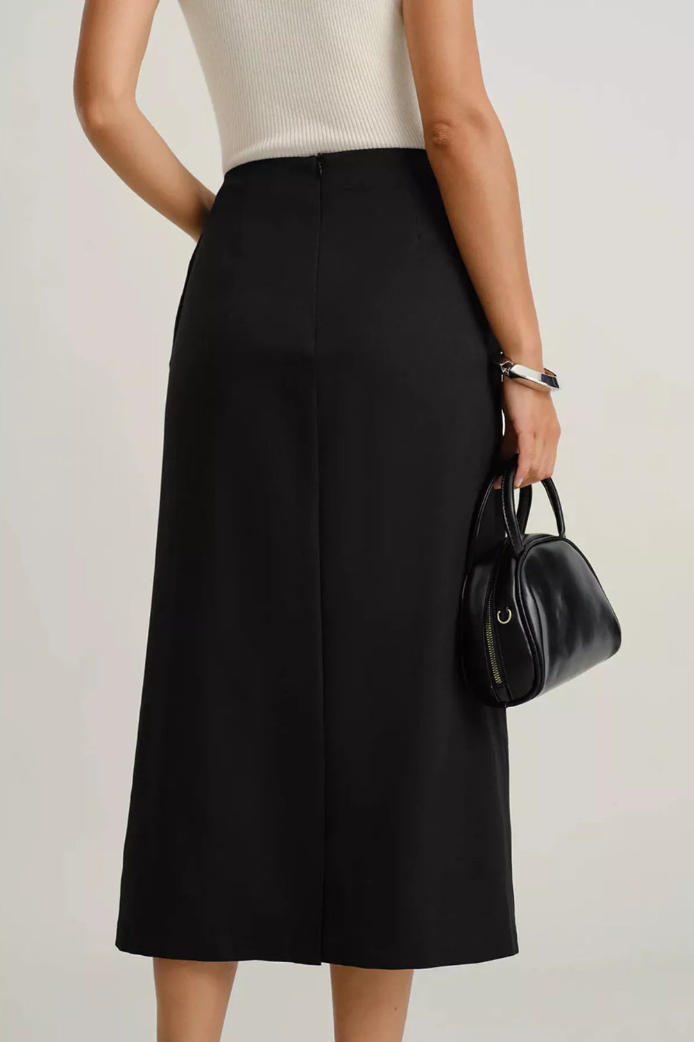 Midi-skirt, buttoned, front patch pockets, back zipper, unlined, some stretch, back view
