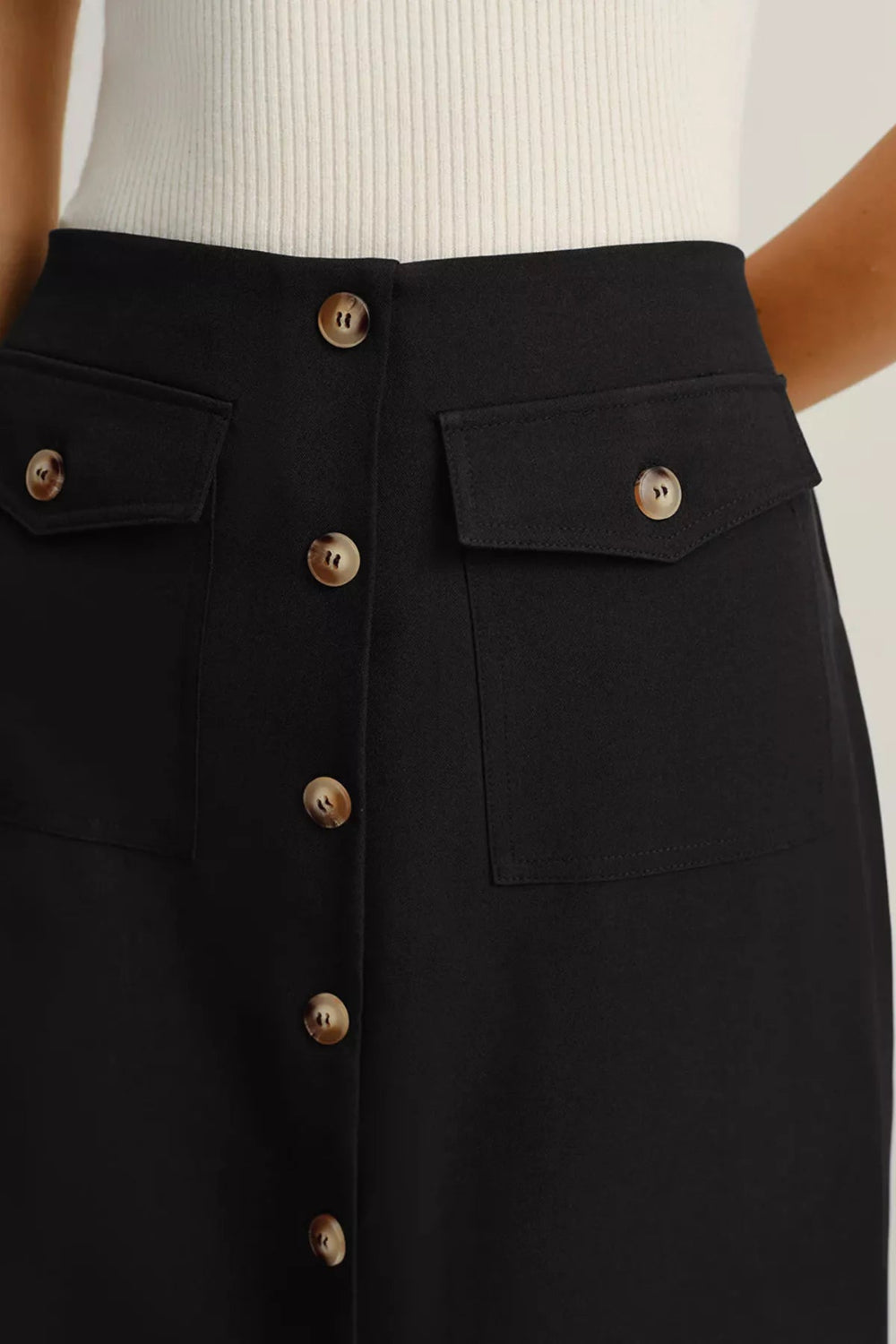 Midi-skirt, buttoned, front patch pockets, back zipper, unlined, some stretch, close up view
