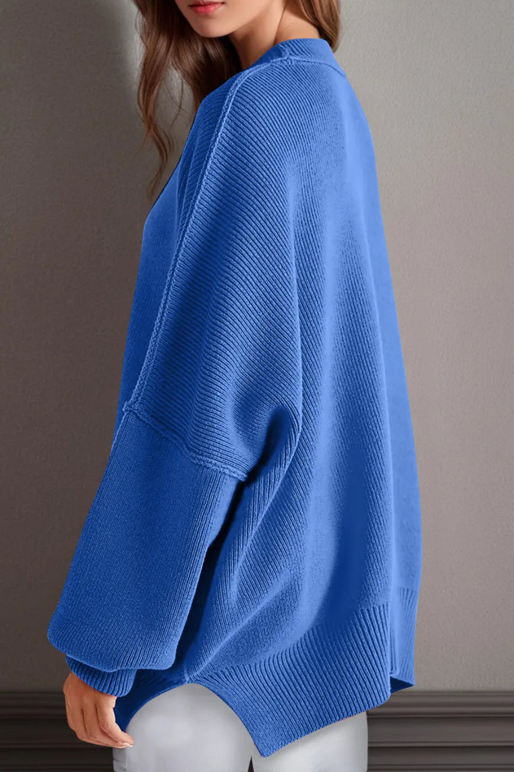 Sweater, oversized, drop shoulder, round neck, exposed seam, long, side slit, ribbed, stretchy side view
