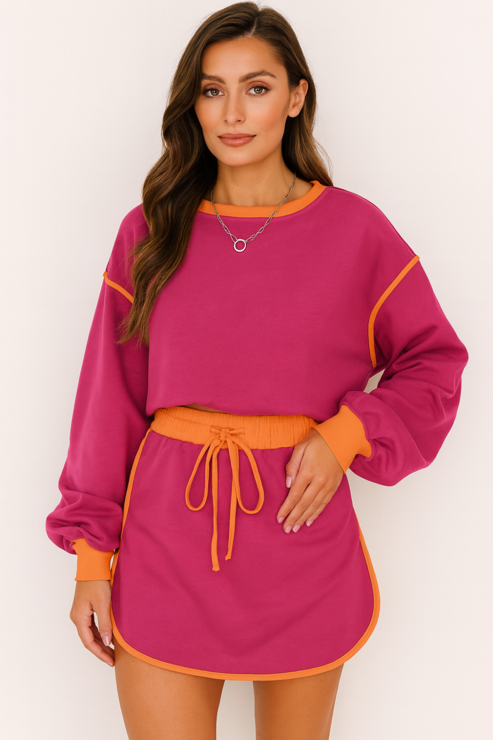 Two-piece skort set, pullover, oversized, long sleeve, drop shoulder, contrast trim, elastic waist, drawstring closure, slightly stretchy front view