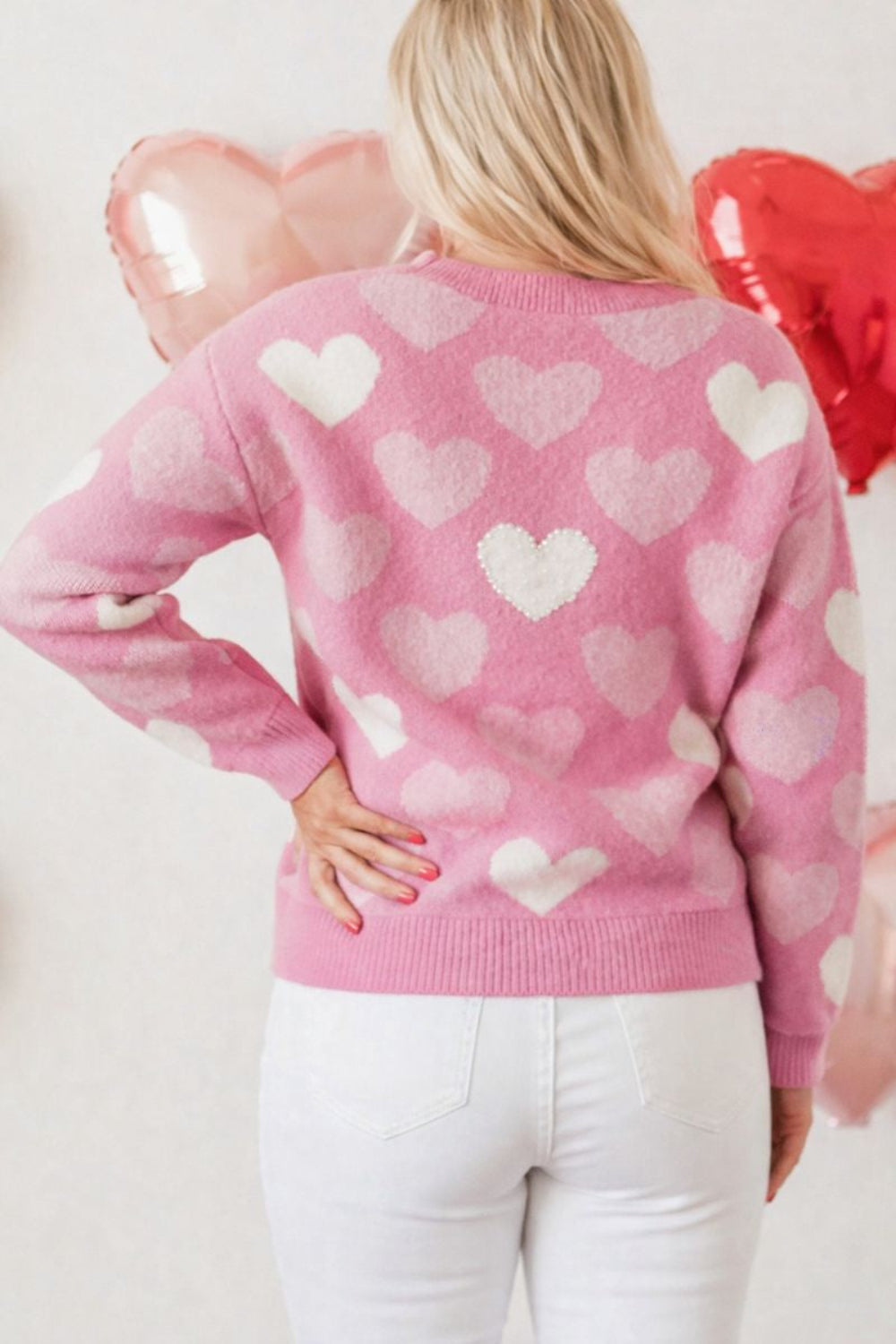 sweater, pullover, long sleeve, round neck, ribbed neck, cuffs and hem, heart print with pearl accents, drop shoulder, fuzzy texture, medium length, slightly stretchy, back view