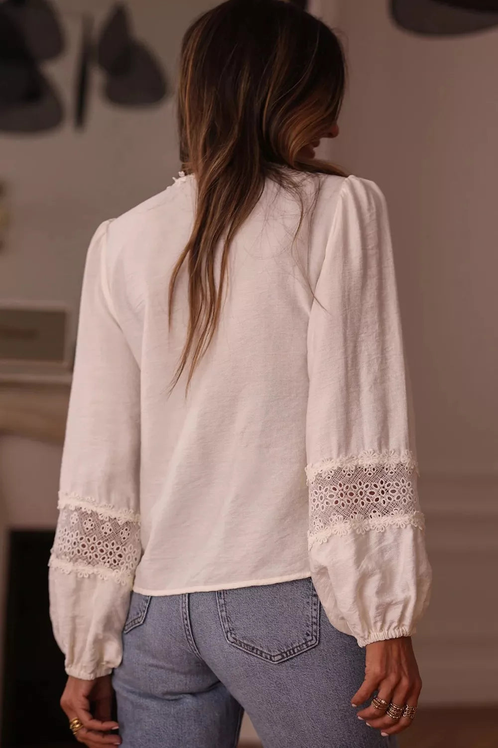 blouse, pullover, v-neck, long sleeve, buttoned, puff sleeve with elastic wrist, lace cutouts, ruffles, intricate detailing on sleeve and neckline, medium length, no stretch, back view