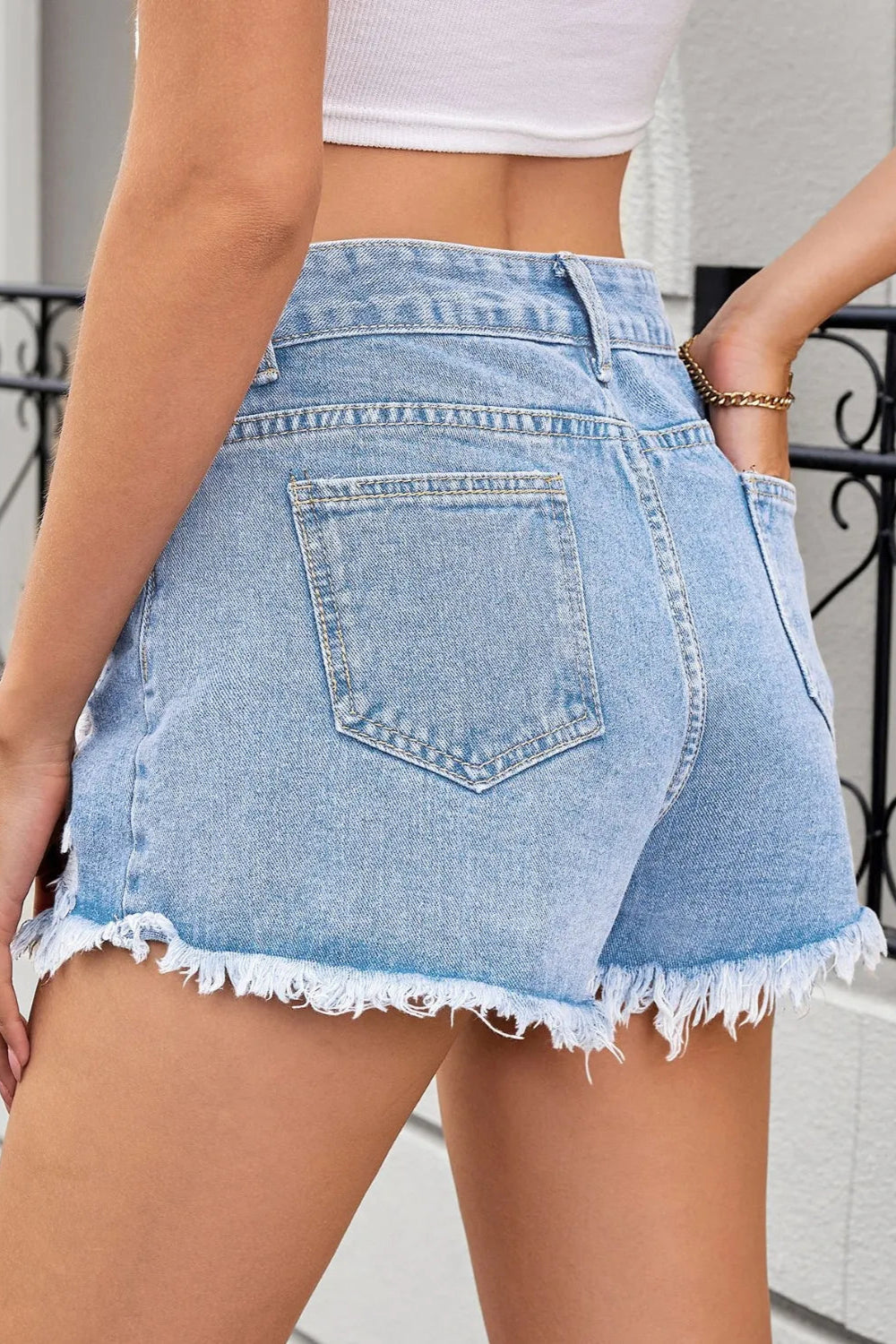 Distressed, Raw hem, High waist, Zipper and button closure, Functioning pockets,  No stretch, Denim shorts Back view