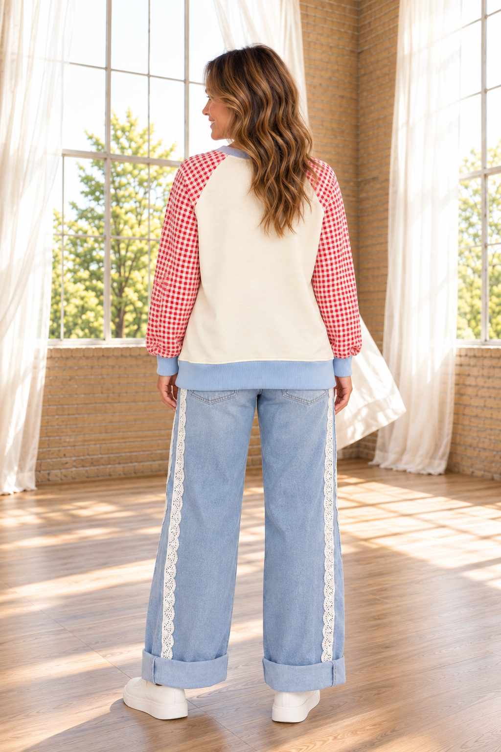 The Second Look Jeans in a light wash with wide cuffed legs, double white lace side panels, and back pockets, shown from the back.