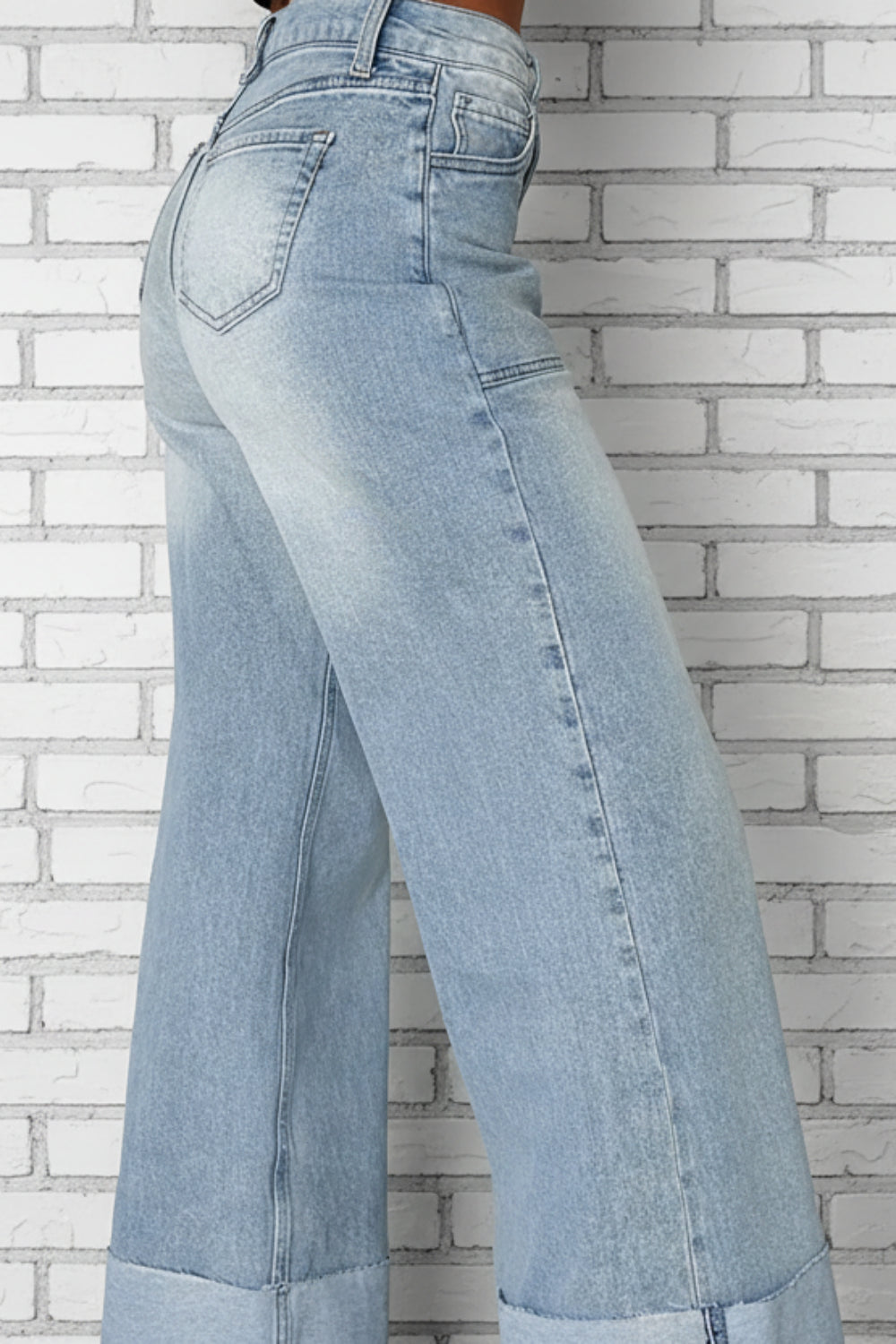 Jeans, high-waist, wide leg, high raw hem cuff, front patch pockets, light vintage wash, back pockets, belt loops, button/zipper closure, relaxed fit, slightly stretchy, side view