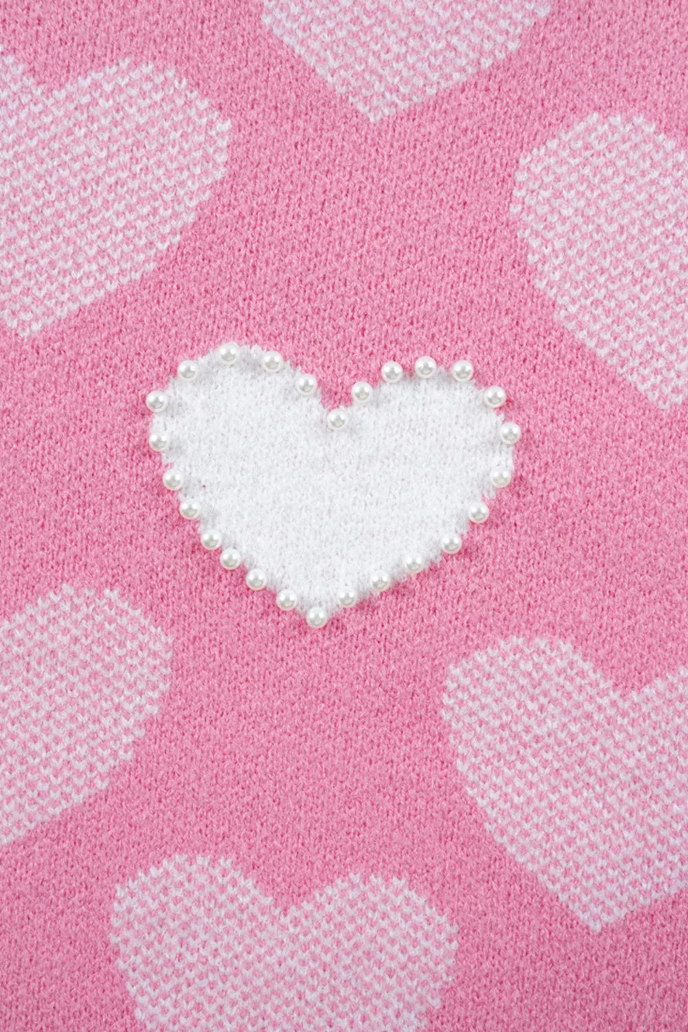 sweater, pullover, long sleeve, round neck, ribbed neck, cuffs and hem, heart print with pearl accents, drop shoulder, fuzzy texture, medium length, slightly stretchy, close up view