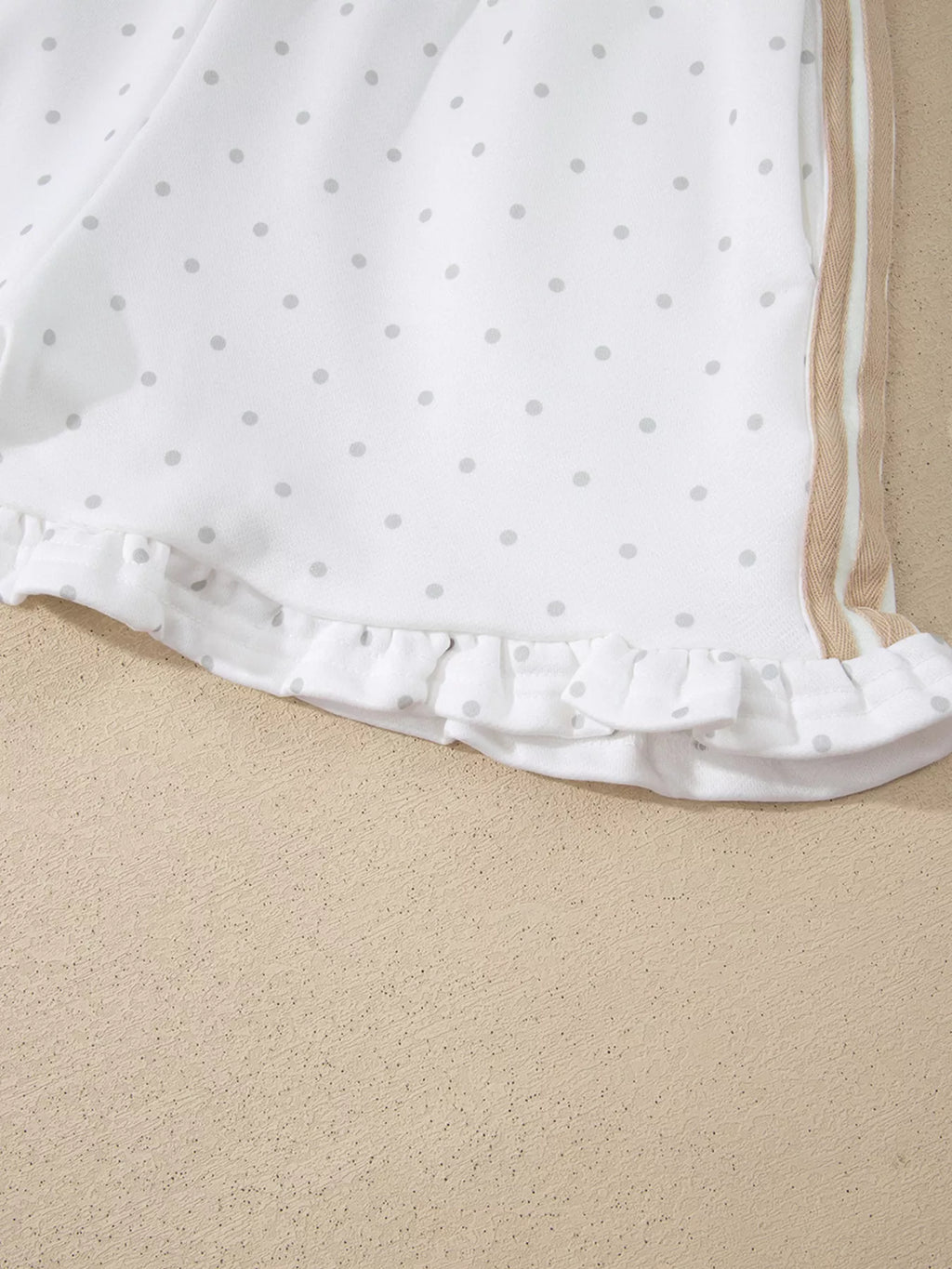 Cozy Dream Short Set in ivory with gray polka dots, a long-sleeve striped top, and matching ruffle-trim shorts close up view.
