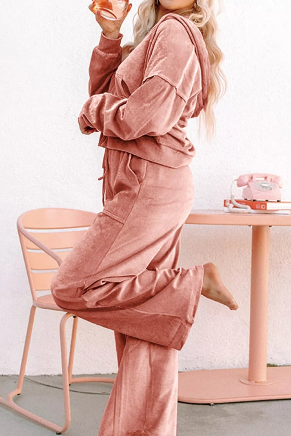 Loungewear set, two-piece, drawstring hoodie, front pockets, zippered, long sleeve, drop shoulder, drawstring bottoms, elastic waist, front pockets, exposed seams, wide leg, slightly stretchy, side view