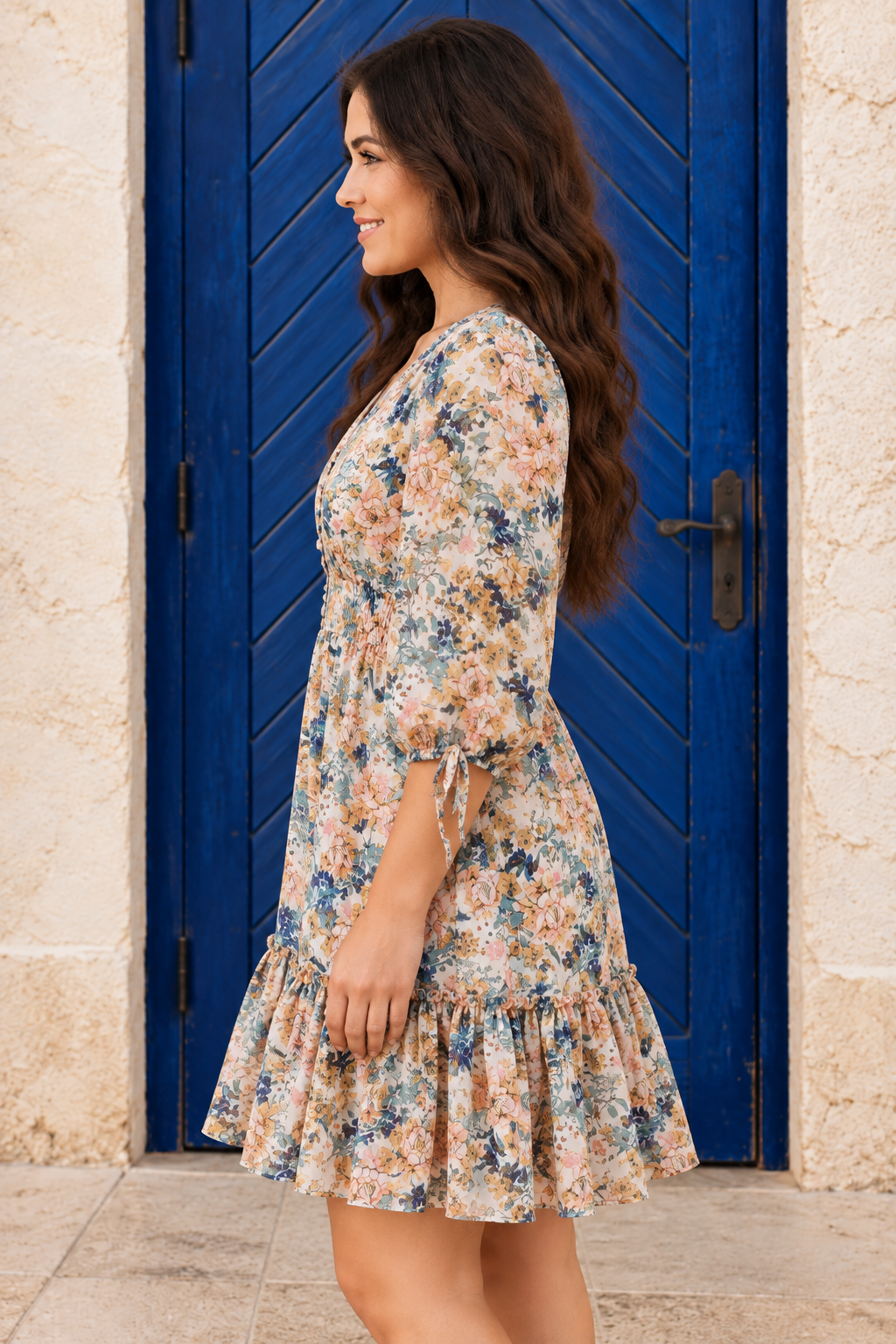 Ever Changing Mini Dress in ivory with multicolor florals, a V-neckline, smocked waist, three-quarter sleeves, and ruffled hem side view.