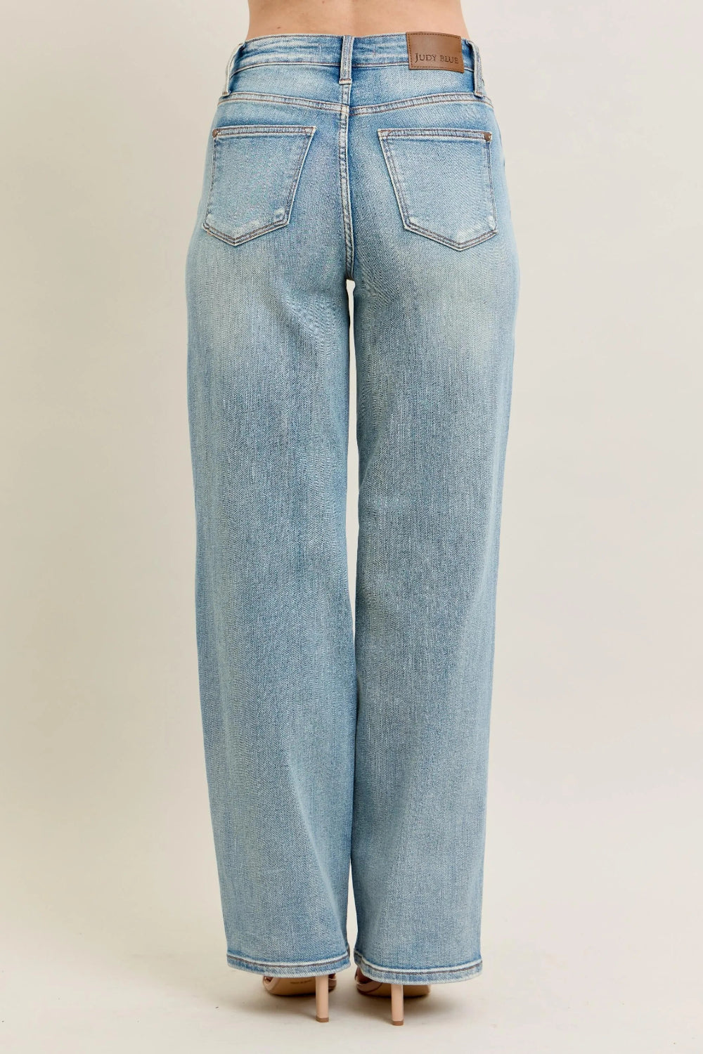 Judy Blue Jeans, full-size, high-rise, destroyed knee patch, distressed, pocketed, button and zipper closure, light wash, slightly stretchy, back view