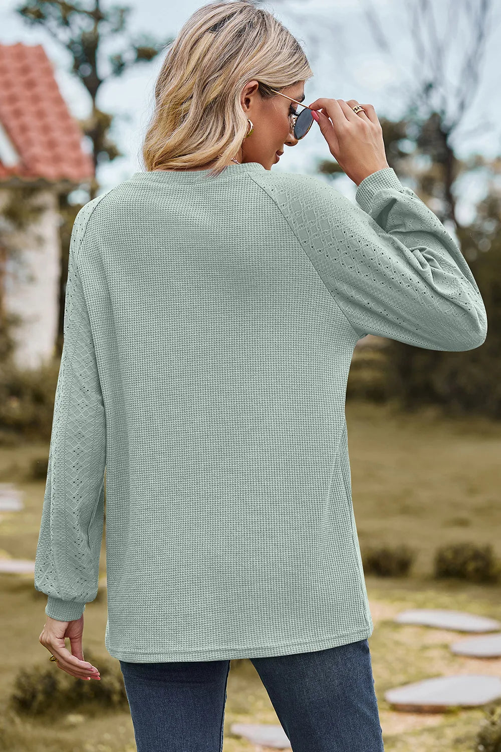 Top, raglan style, round neck, long sleeve, eyelet sleeves, ribbed, opaque, slightly stretchy, back view