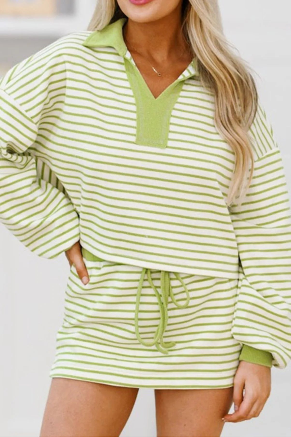 Two-piece mini skirt set, long sleeve, collared, contrast hem, v-neck, drop shoulder, pullover, striped, elastic waist, medium length, striped, elastic waist, drawstring, slightly stretchy front view
