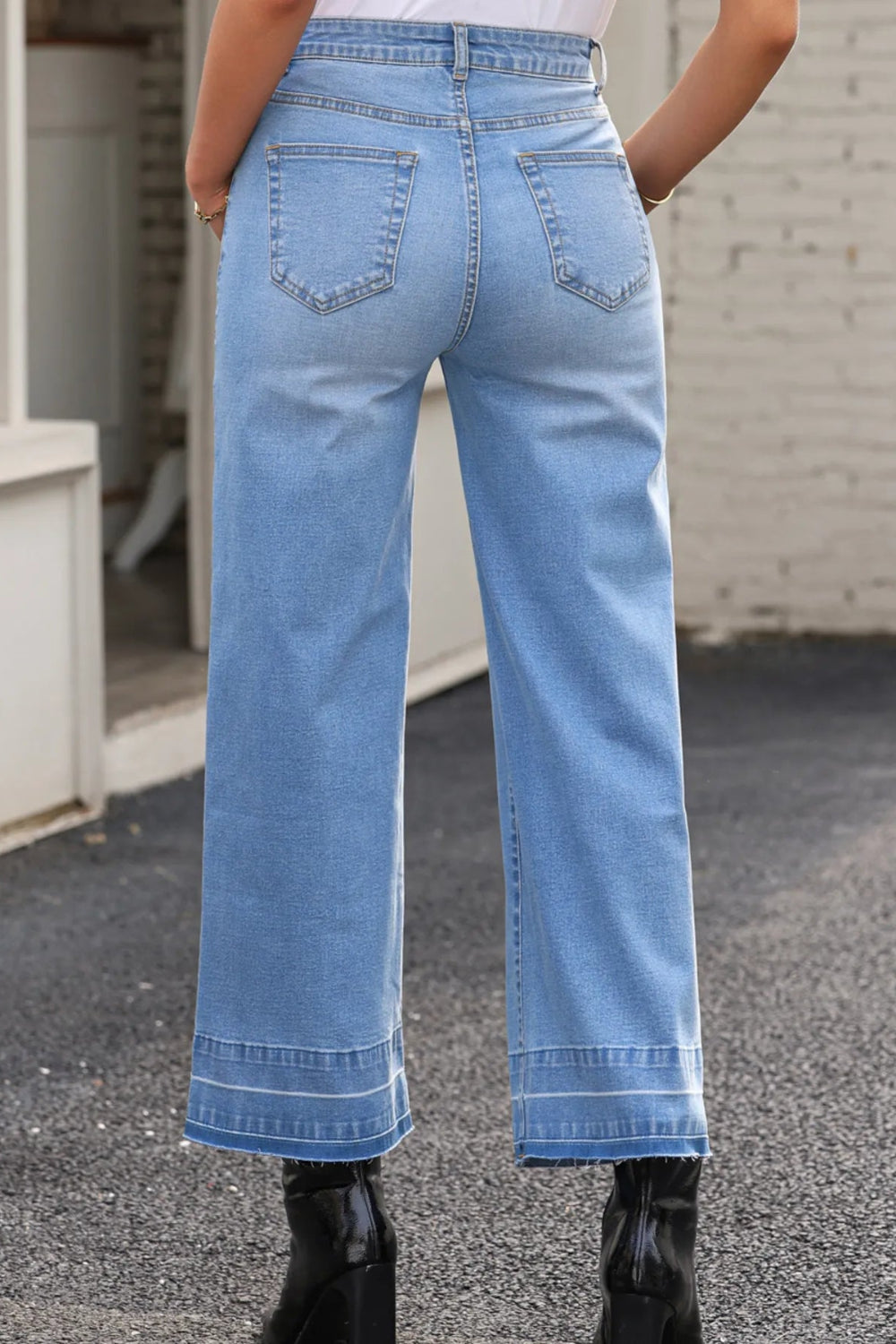 Jeans, high-rise, drop hem, raw hem, wide leg, pocketed, belt loops, button/zipper closure, vintage wash, some stretch, back view