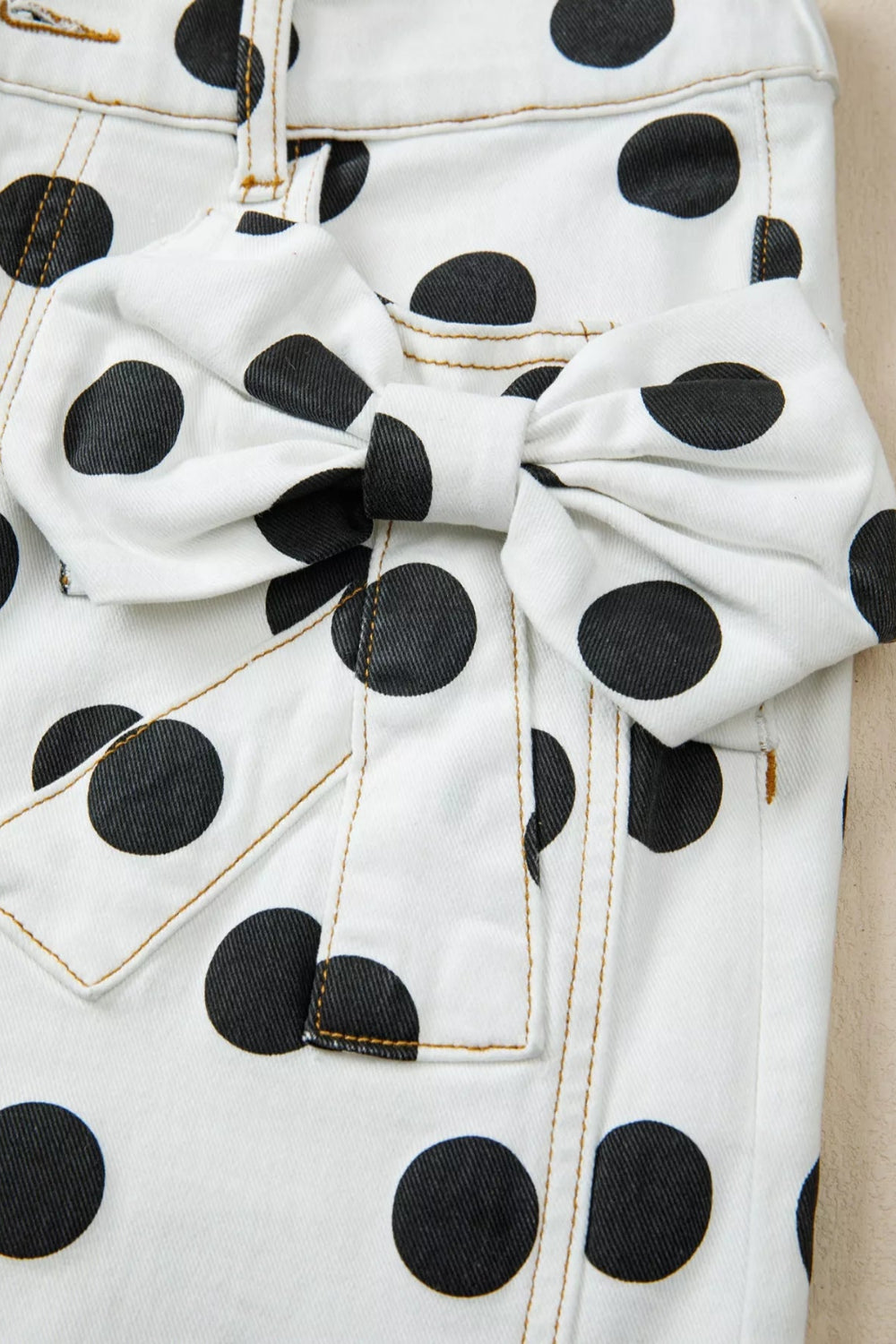 * Jeans
* Polka dot print
* Pocketed
* Belt loops
* Button/zipper closure
* Bow ties
* High-waist
* Loose fit
* Stretchy