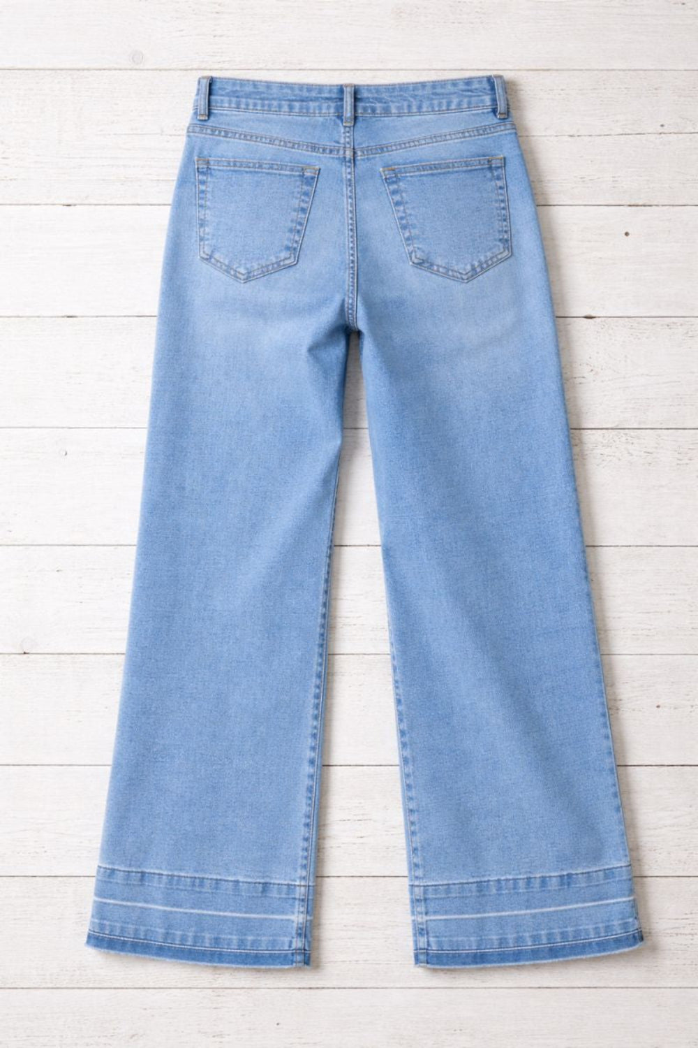 Jeans, high-rise, drop hem, raw hem, wide leg, pocketed, belt loops, button/zipper closure, vintage wash, some stretch, back view