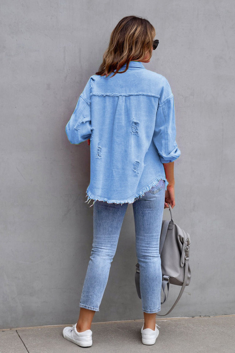 denim jacket, long sleeve, collared, buttoned, buttoned front patch pockets, distressed, fringed/raw hem, no stretch, multiple colors, back view