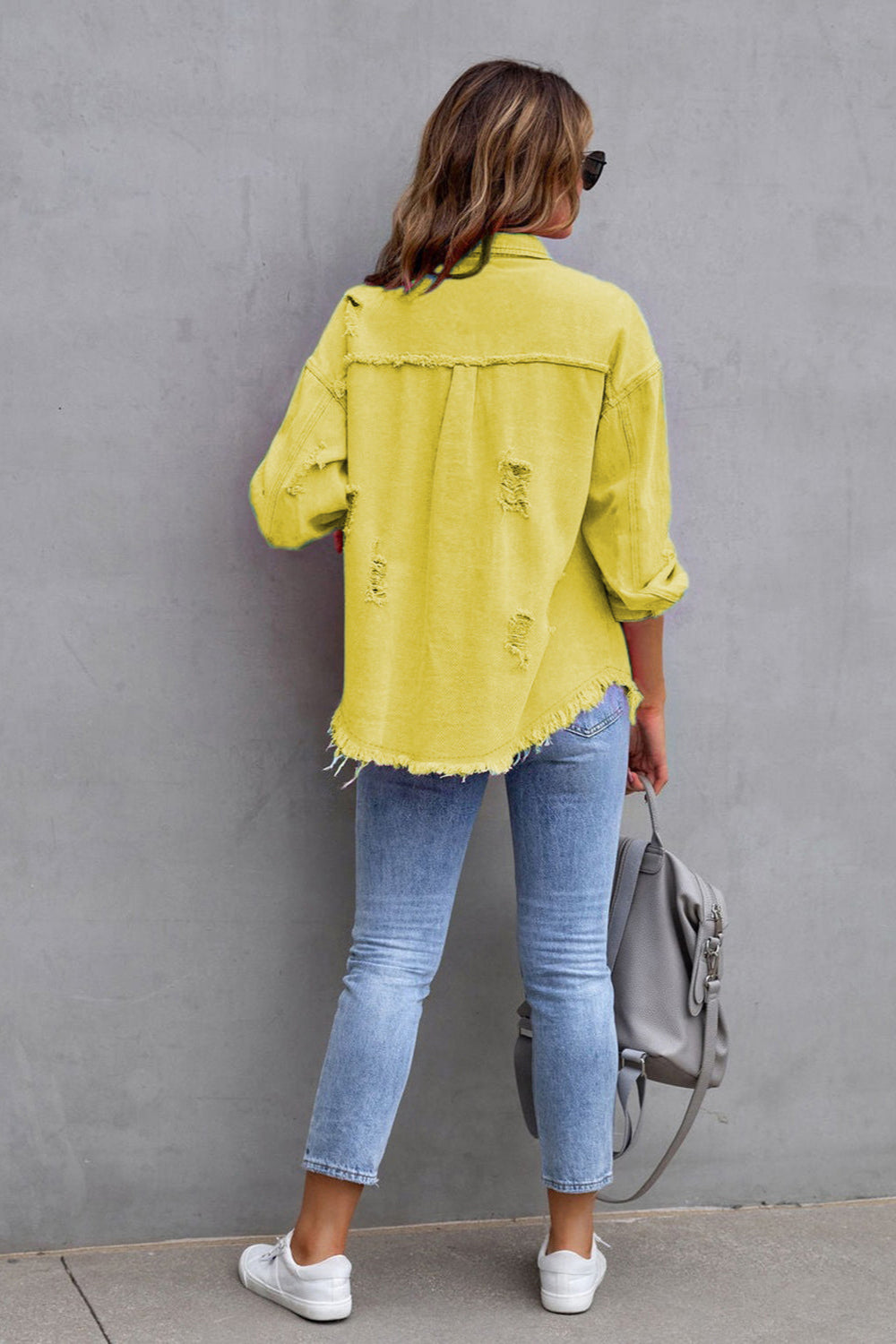 denim jacket, long sleeve, collared, buttoned, buttoned front patch pockets, distressed, fringed/raw hem, no stretch, multiple colors, back view