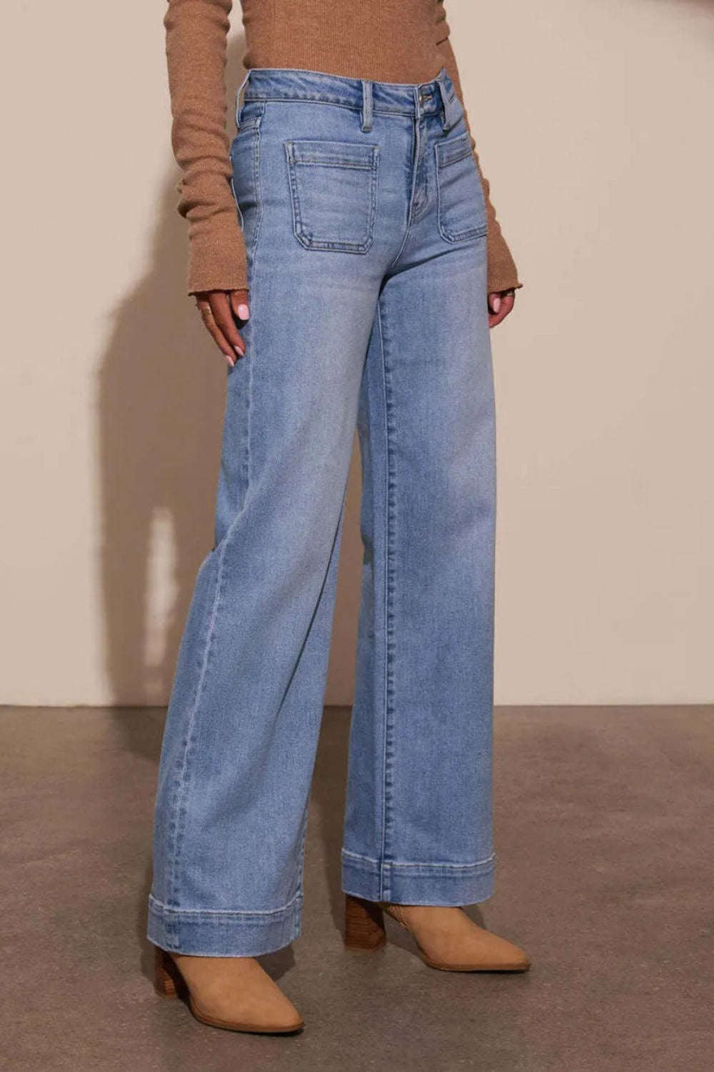 Jeans, high-waist, vintage wash, wide leg, front patch pockets, raw hem, back pockets, wide cuff, vintage wash, button/zipper closure, belt loops, slightly stretchy, side view