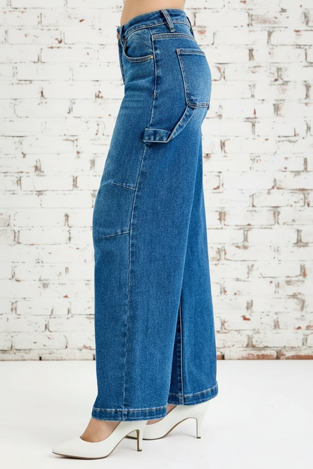 Risen Jeans, full-size, high-rise, darted, wide leg, one side hammer loop, pocketed, belt loops, button/zipper closure, washed, raw hem, slightly stretchy, side view
