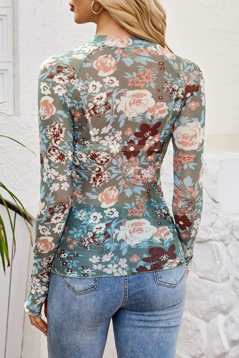 top, mesh, floral print, mock neck, long sleeve, thumb hole, stretchy, back view