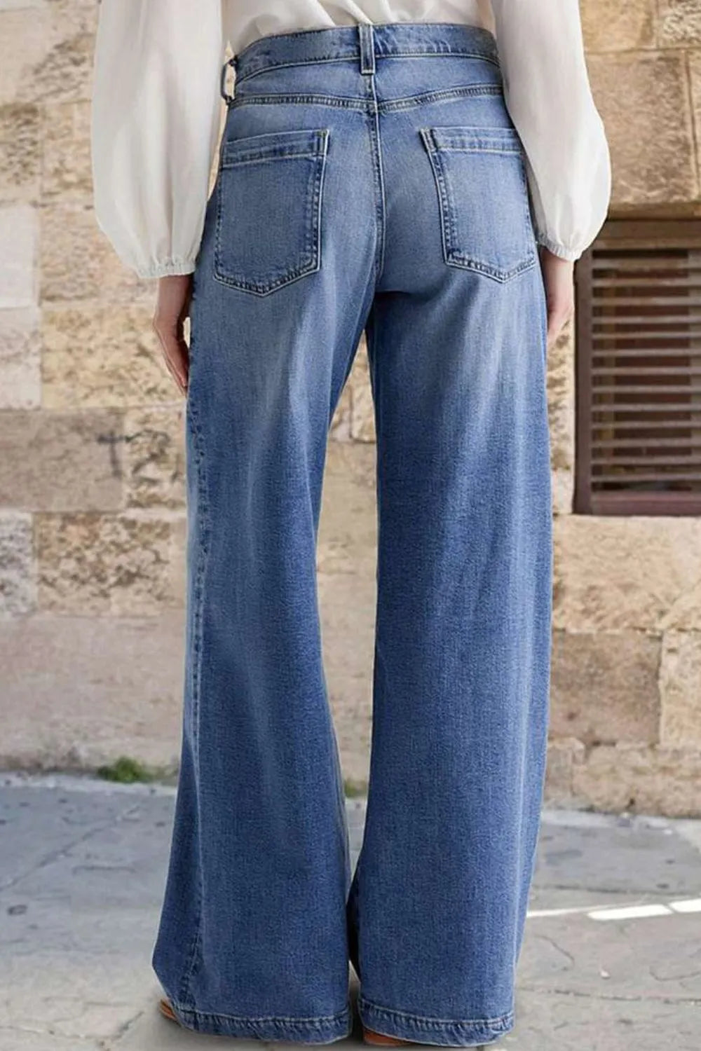Jeans, high-waist, vintage wash, wide leg, front embroidered pockets, raw hem, back pockets, button/zipper closure, belt loops, slightly stretchy, back view