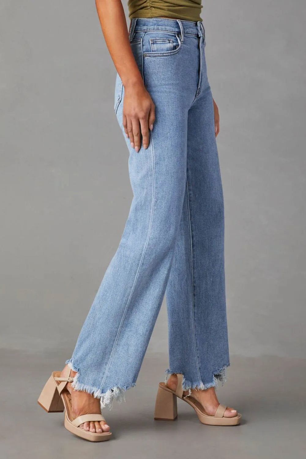 Jeans, high-waist, straight leg, 5 pocket design, light wash, raw hem, destroyed, button/zipper closure, belt loops, slightly stretchy, side view