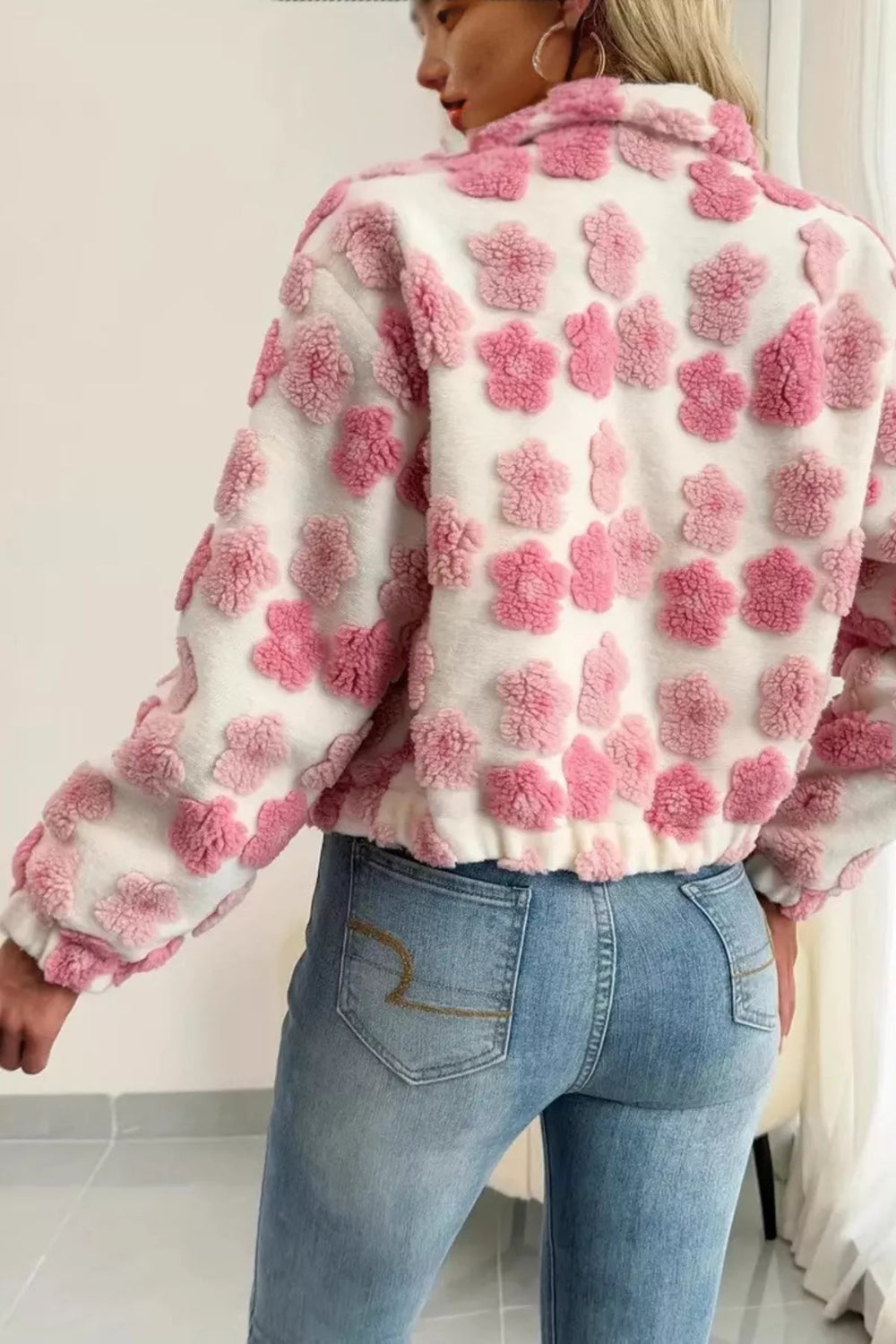 Jacket, unlined, collared, zippered, pocketed, puffy fleece flowers, oversized, sits at the waist, elastic waist and cuffs, no stretch, back view
