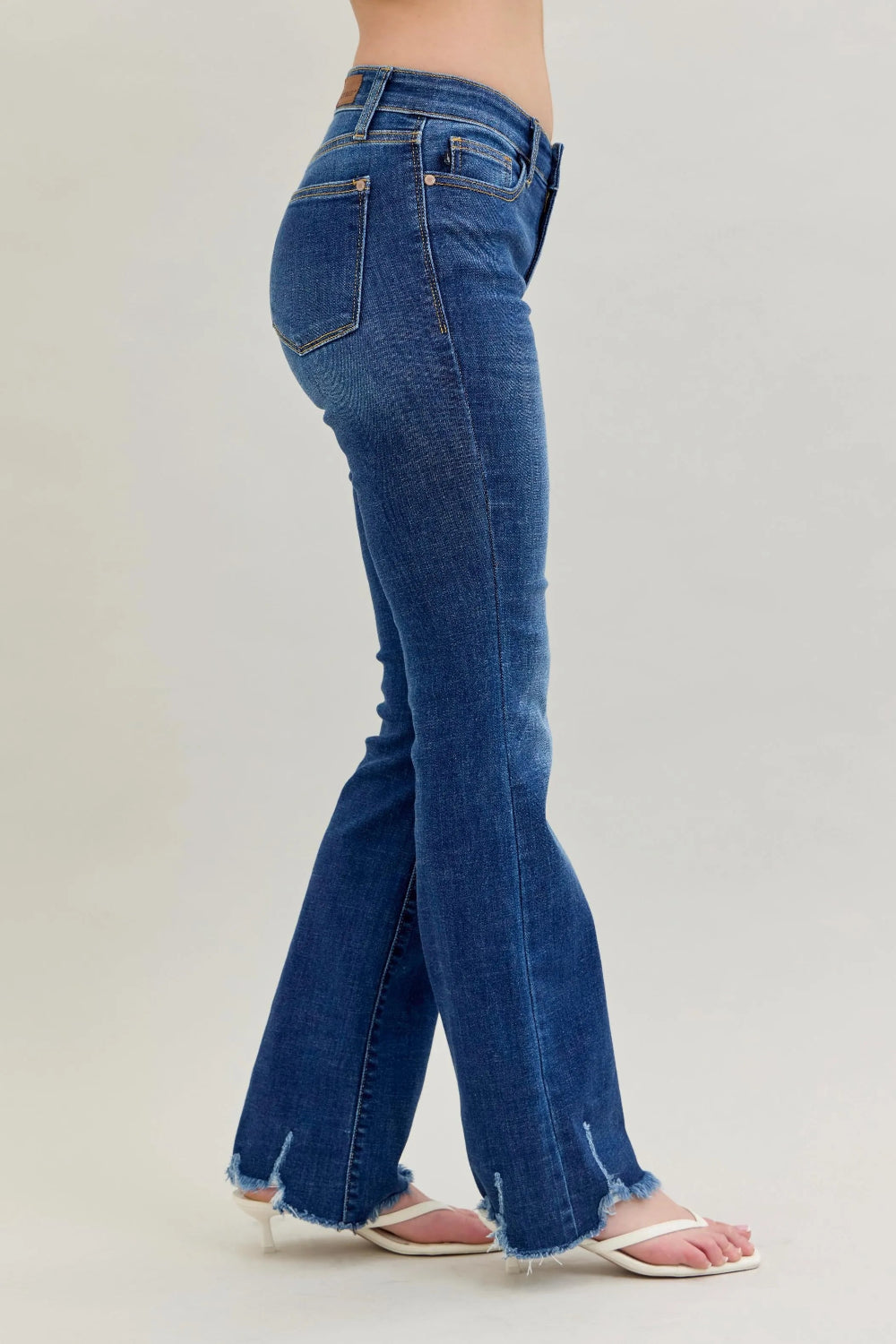 Judy Blue Jeans, full-size, mid-rise, vintage dark wash, 5-pocket design, relaxed fit, button-zip closure, distressed hem, subtle whiskering, bootcut, slightly stretchy, side view