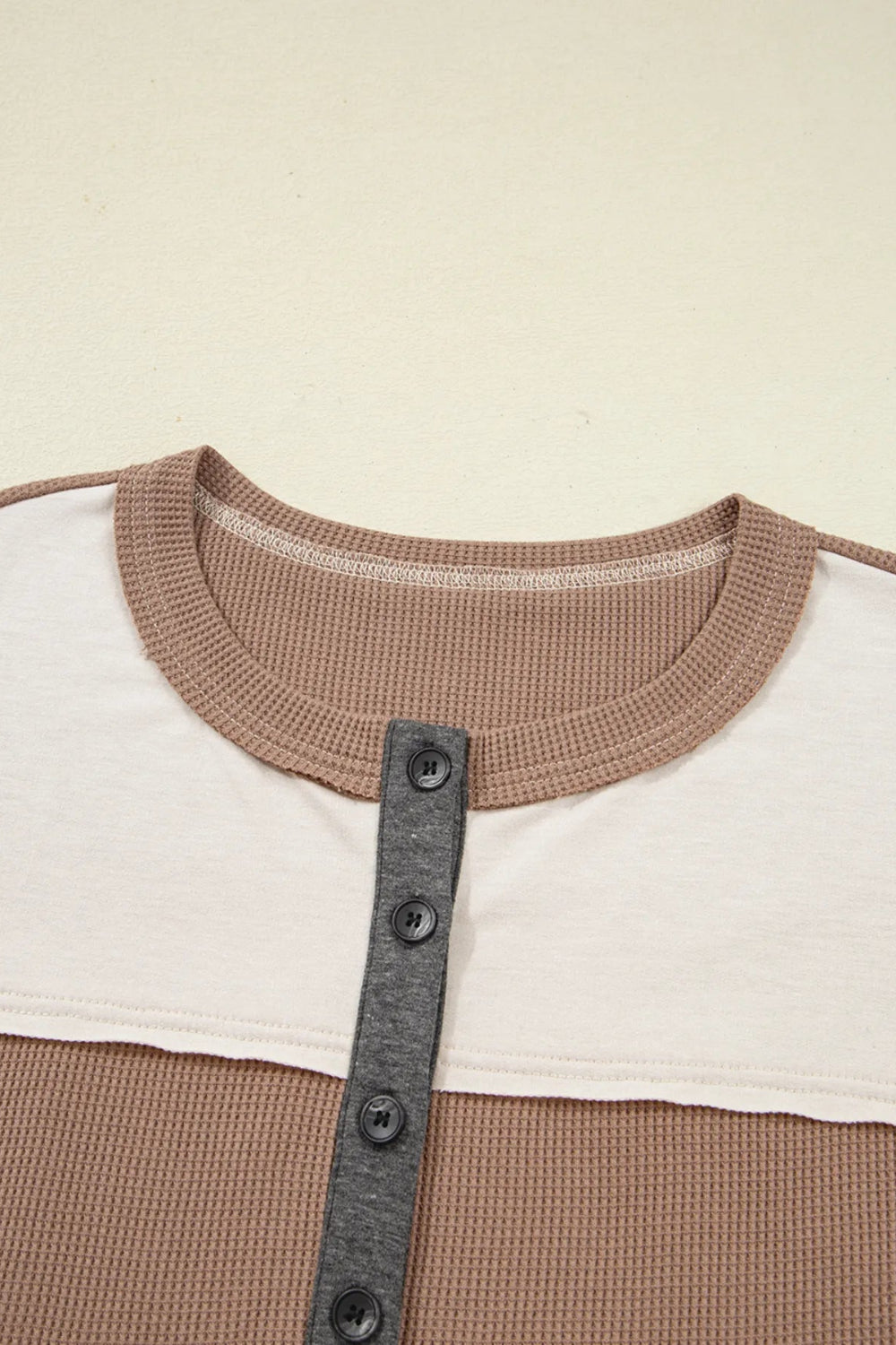 Top, henley, pullover, long sleeve, round neck, color block, waffle-knit, buttoned, slightly stretchy, close up view