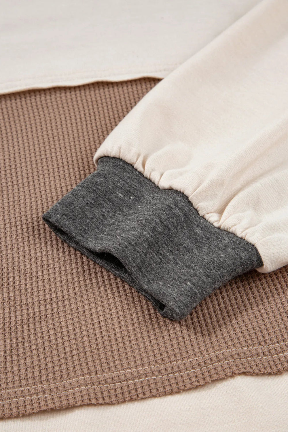 Top, henley, pullover, long sleeve, round neck, color block, waffle-knit, buttoned, slightly stretchy, close up view