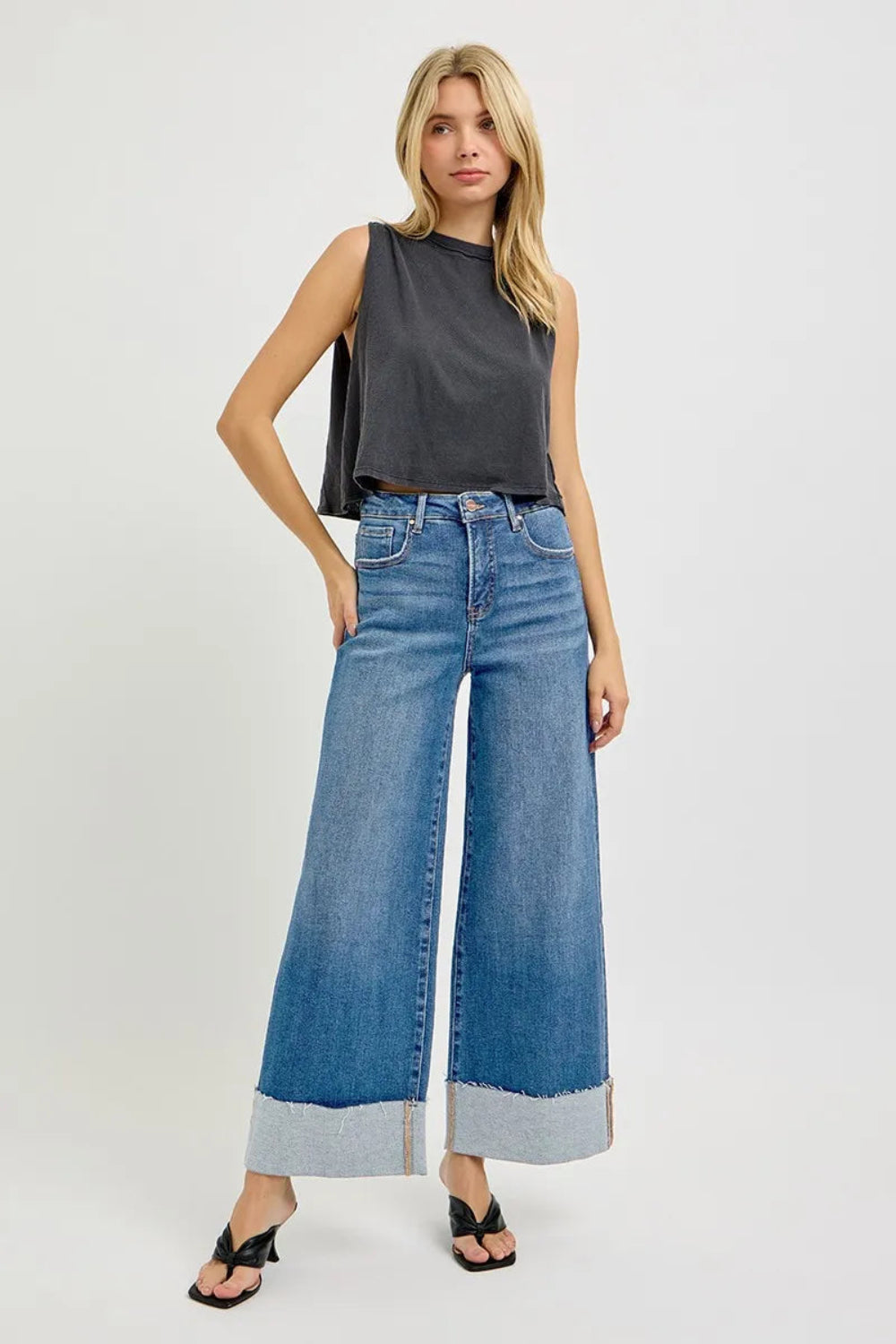 Risen blue jeans, full-size high-rise, tummy control, cropped, wide leg, cuffed, 5-pocket detail, button-zipper closure, belt looped, raw hem, medium wash, slightly stretchy, front view
