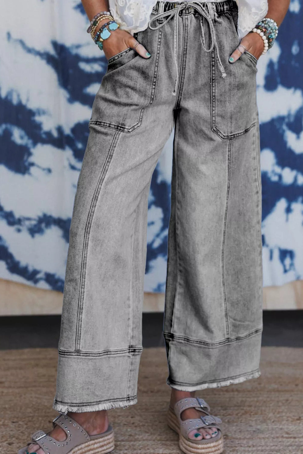 Pants, denim, high-rise, elastic waist, drawstring, belt loops, pocketed front and back, raw/frayed hem, wide leg, slightly stretchy, front view
