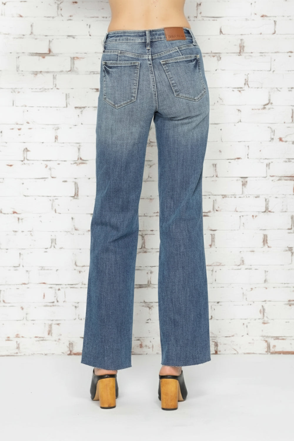 Judy Blue Jeans, full-size, tummy control, straight leg, pocketed, belt loops, button/zipper closure, light vintage wash, raw hem, stretchy, back view